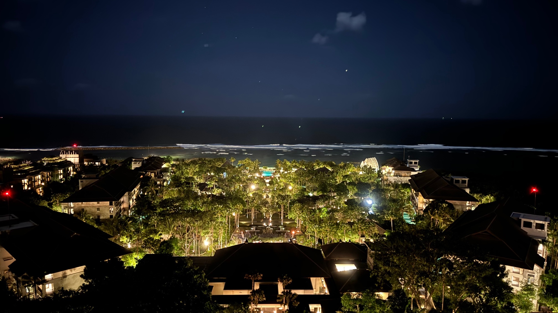 Ritz-Carlton Bali grounds and ocean illuminated at night