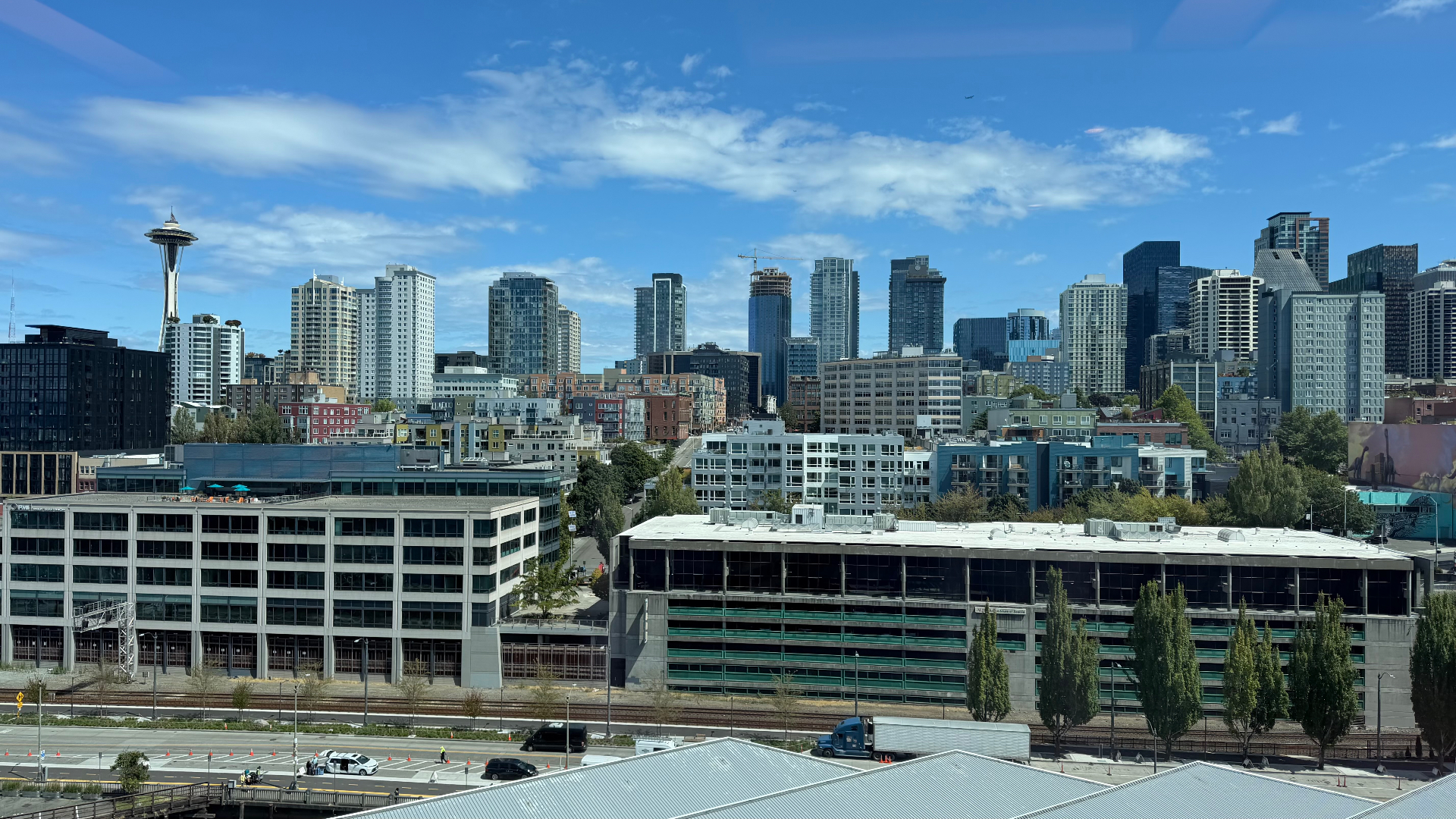 The Seattle skyline with the Space Needle visible, seen from the cruise terminal at Pier 66 under a bright sky