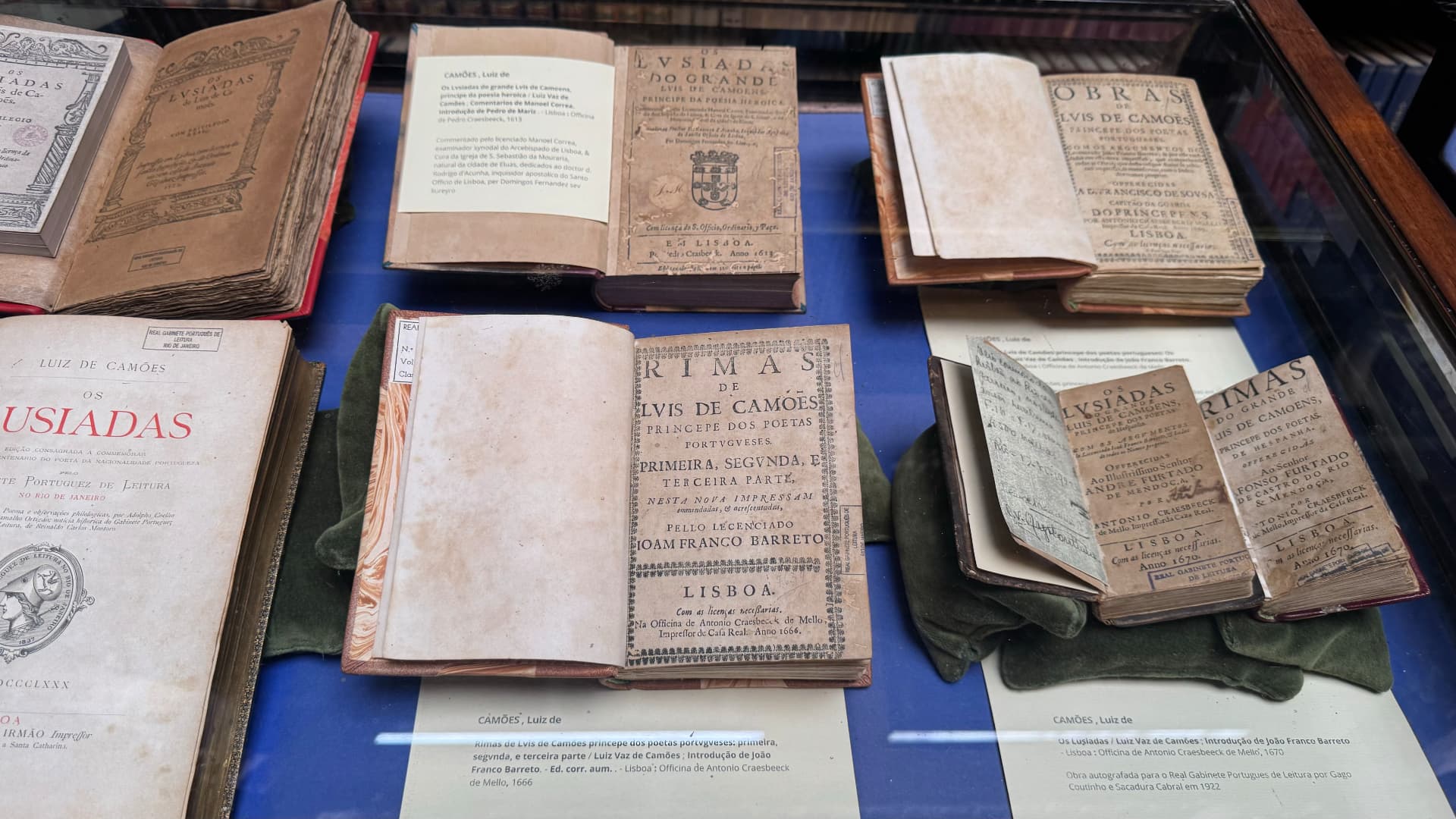 Historic editions of works by Luís de Camões displayed beneath glass