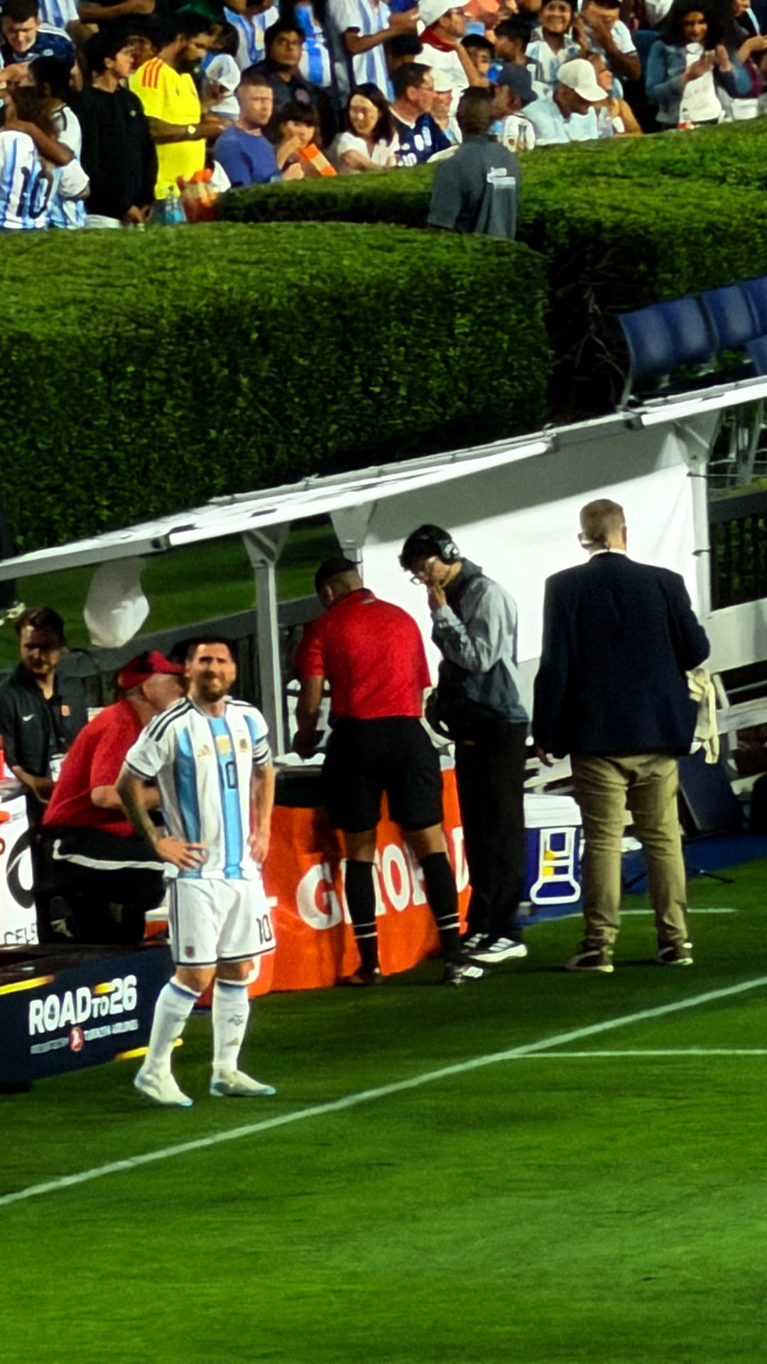Lionel Messi standing beside the Argentina bench