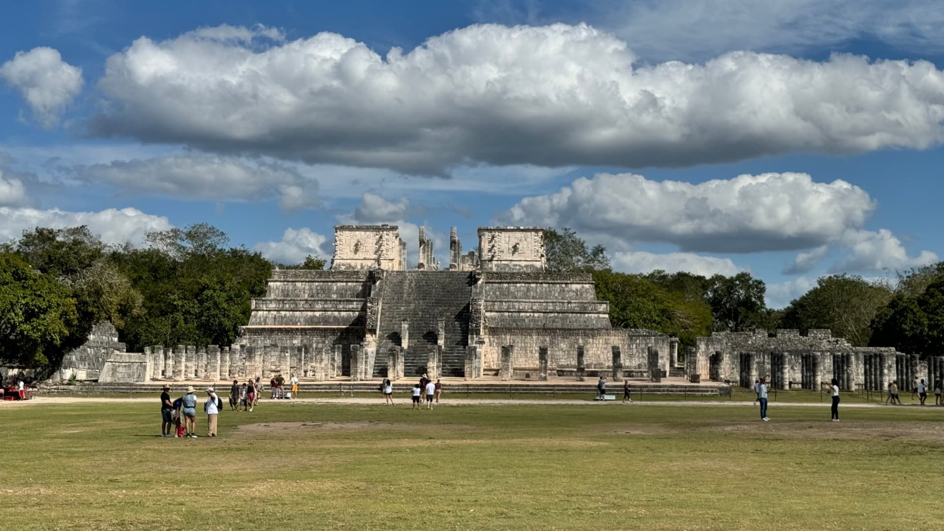 Temple of the Warriors and its surrounding columns beneath broad white clouds