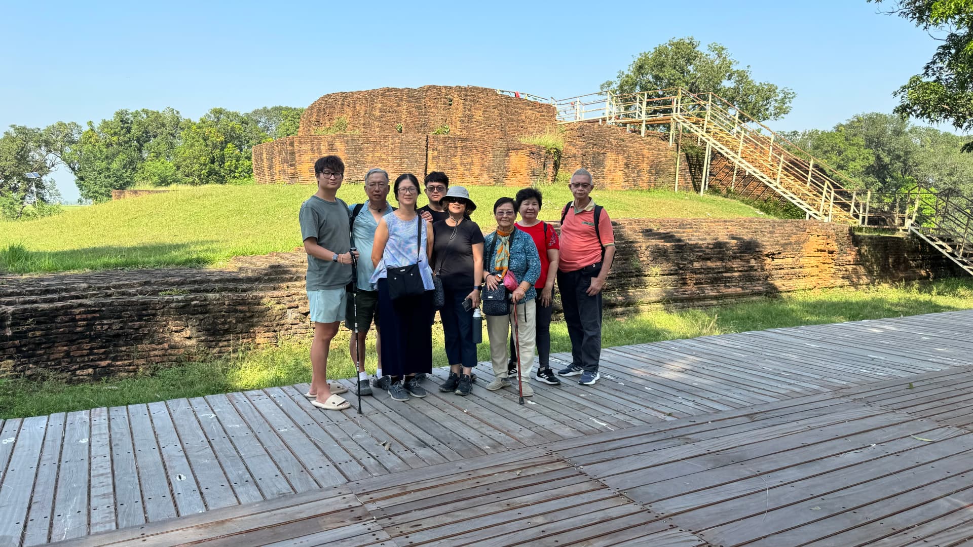 Our group gathers beside the boardwalk and archaeological remains. — Sacred sites near Lumbini, Nepal.