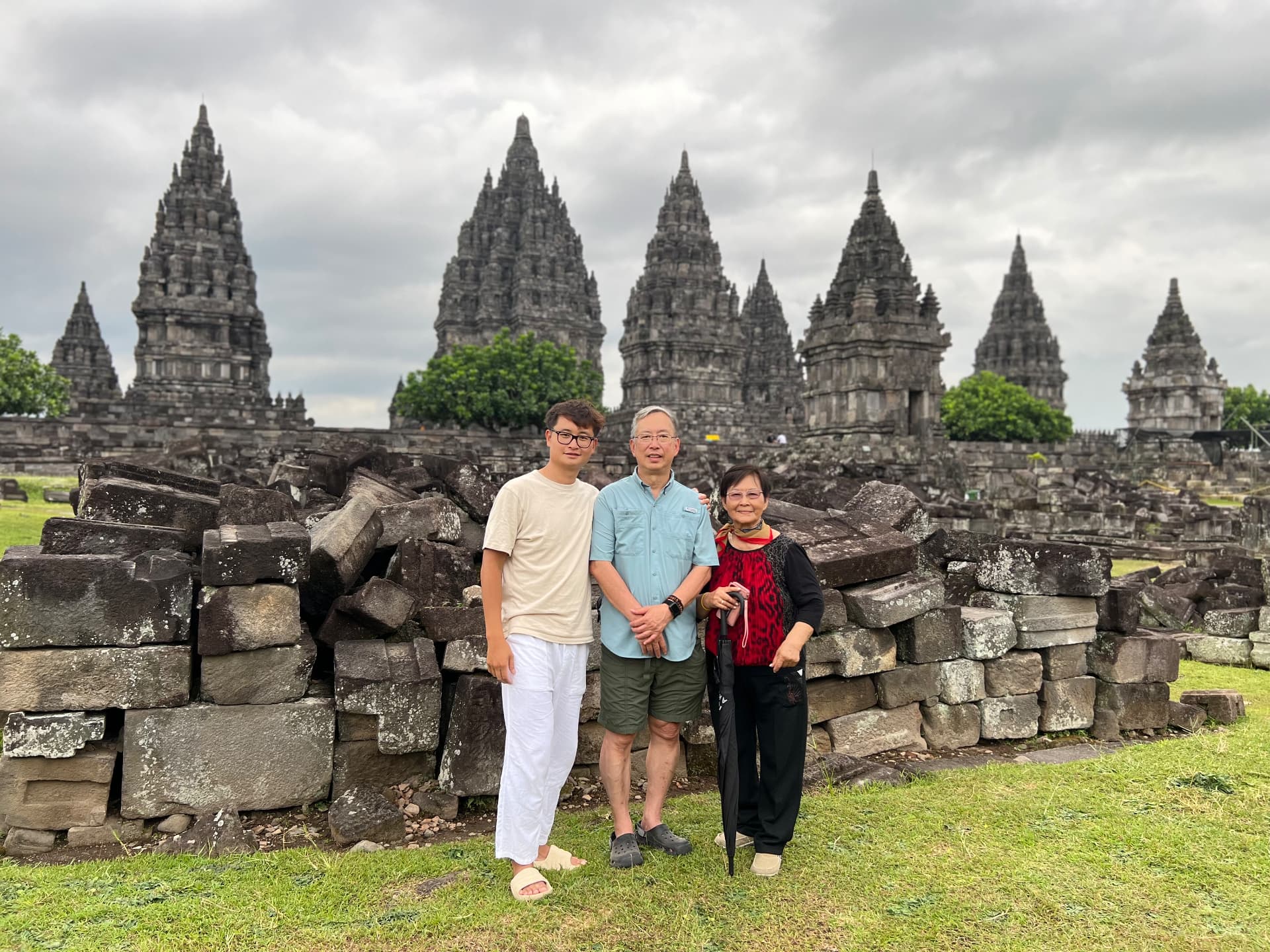 Three travelers standing before the Prambanan temple complex