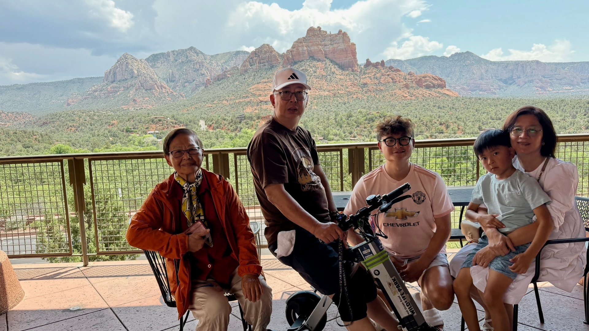 The family posing together on the terrace with red rocks behind