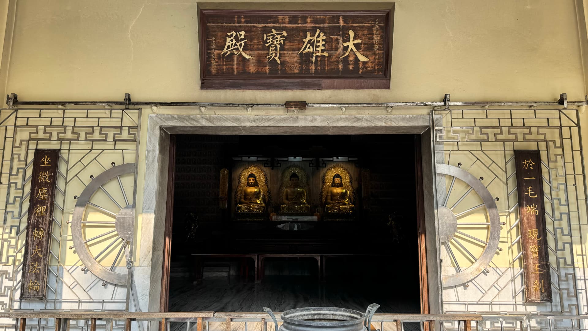 A richly decorated shrine entrance opens into a dim interior. — Bodh Gaya, Bihar, India.