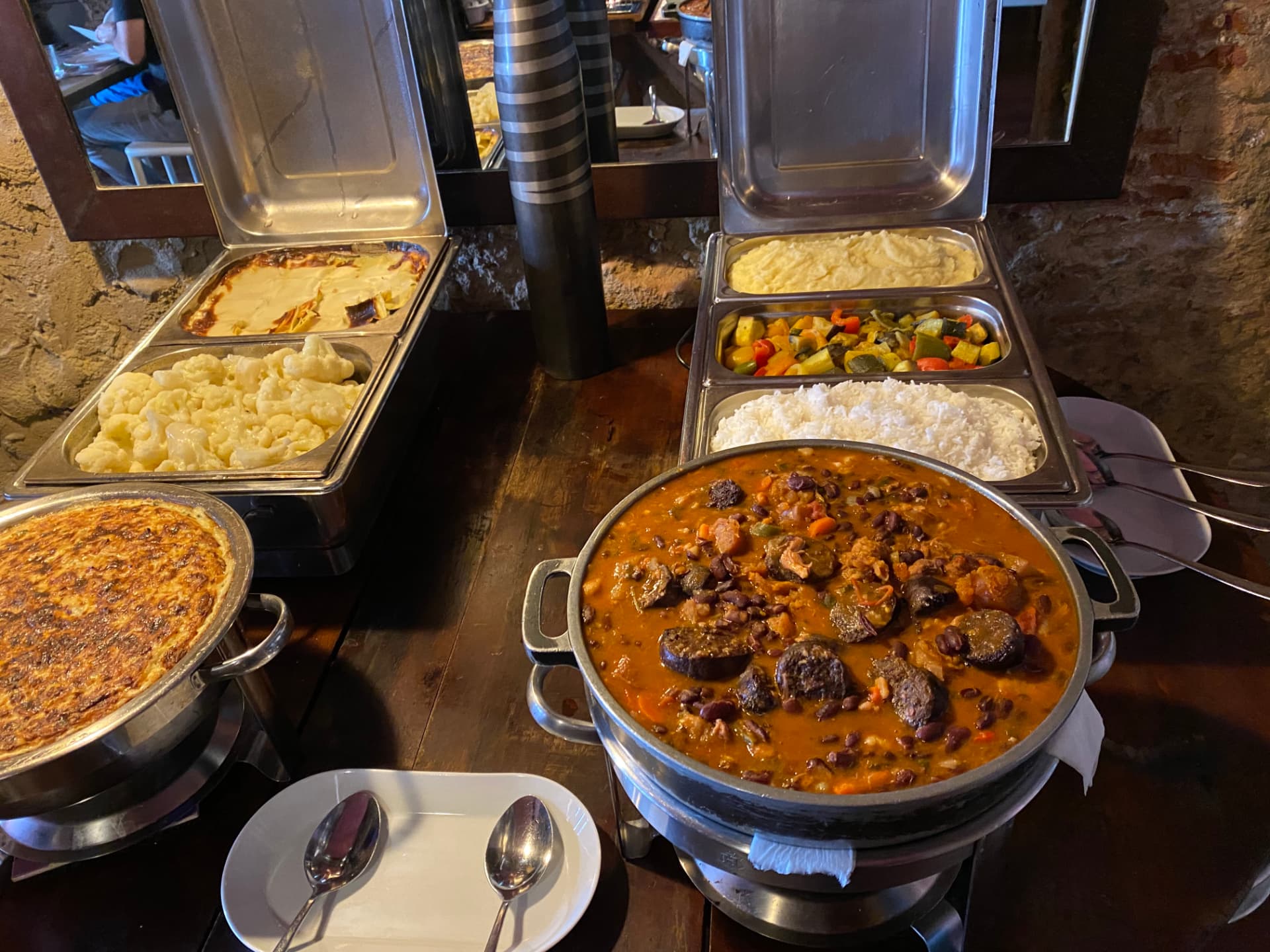 Metal buffet trays filled with hot dishes
