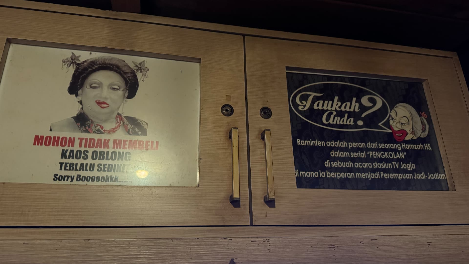 Signs and portraits displayed inside the House of Raminten