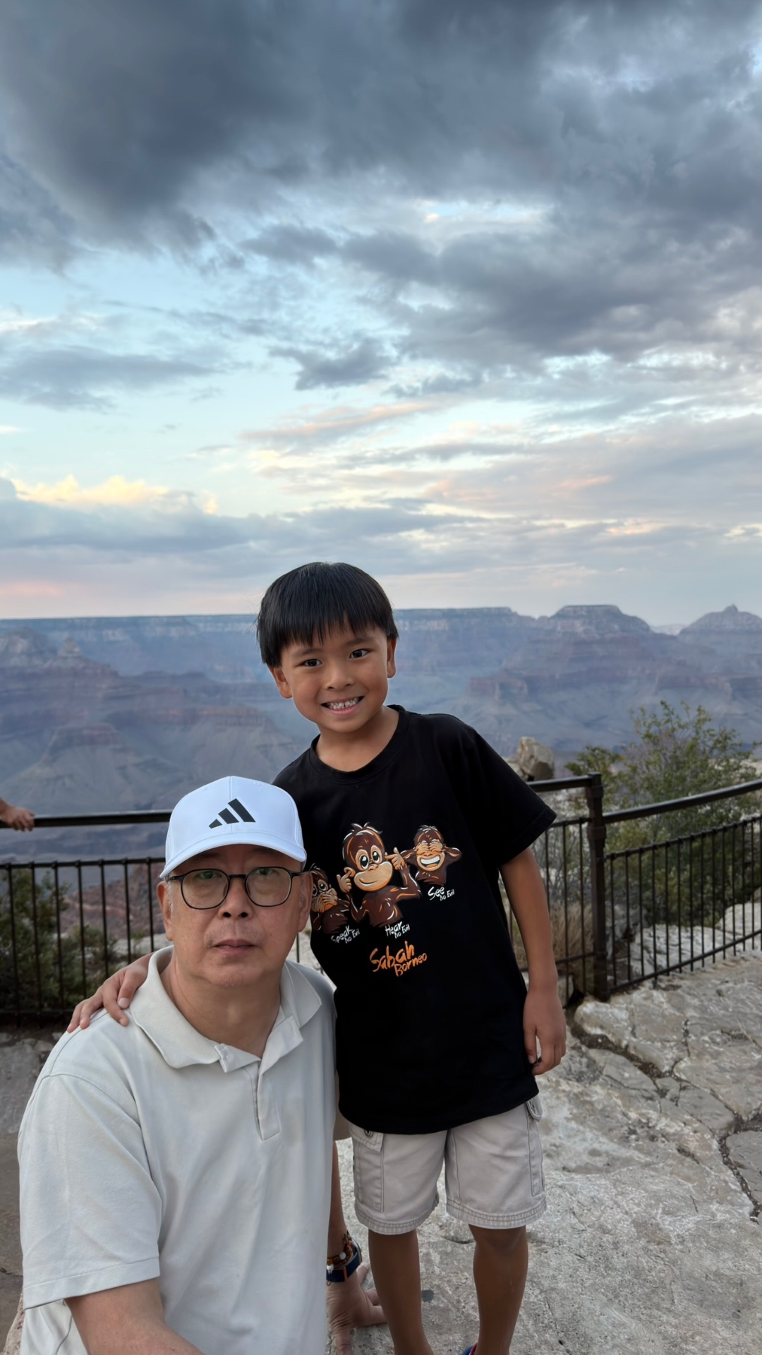 Ken and Kayden at the canyon rim railing