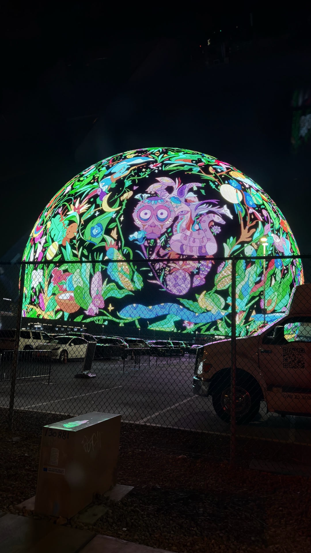The Sphere in Las Vegas at night, lit with a jungle of birds and flowers