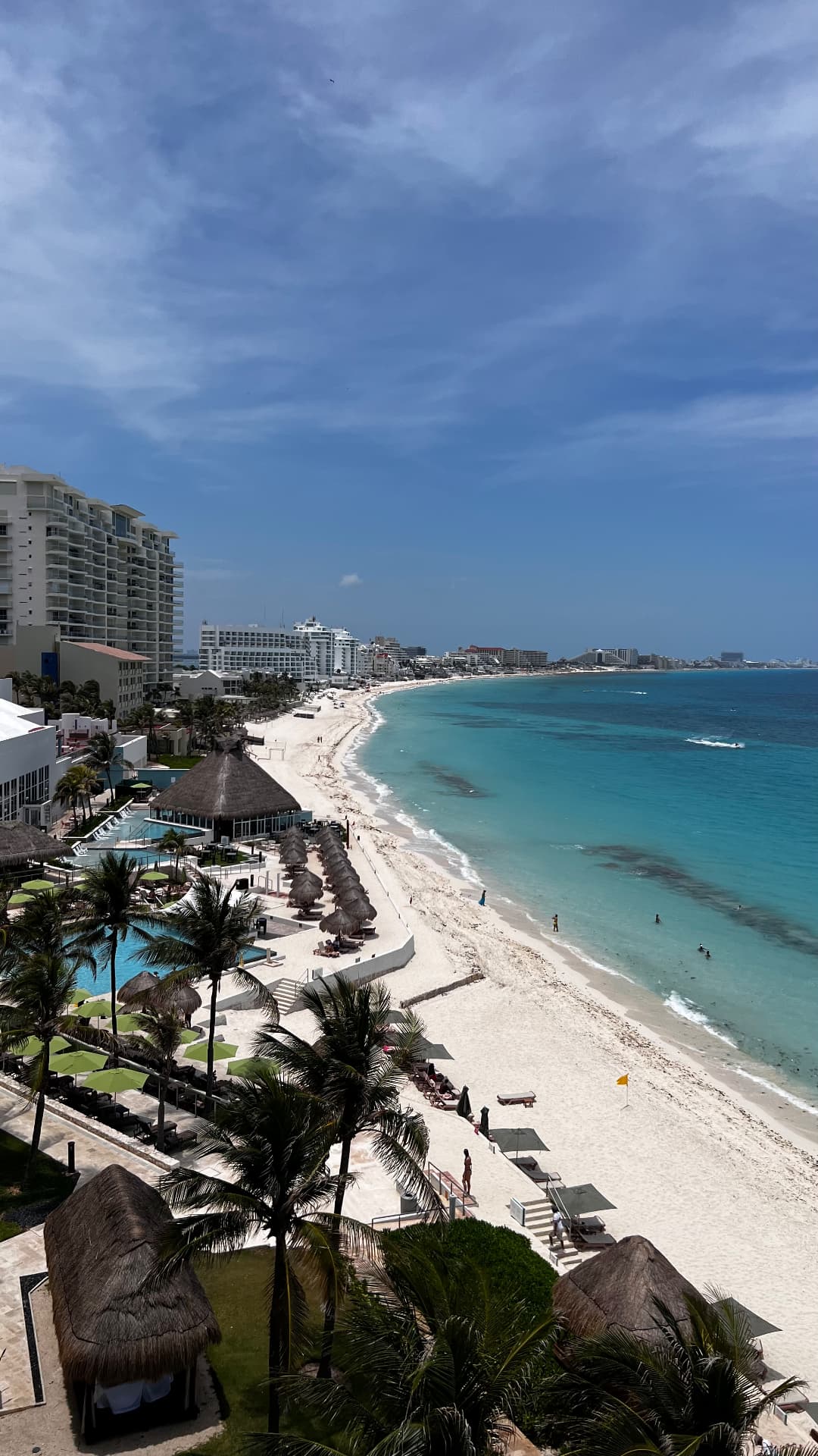 High view along Cancún's white beach and hotel-lined coast