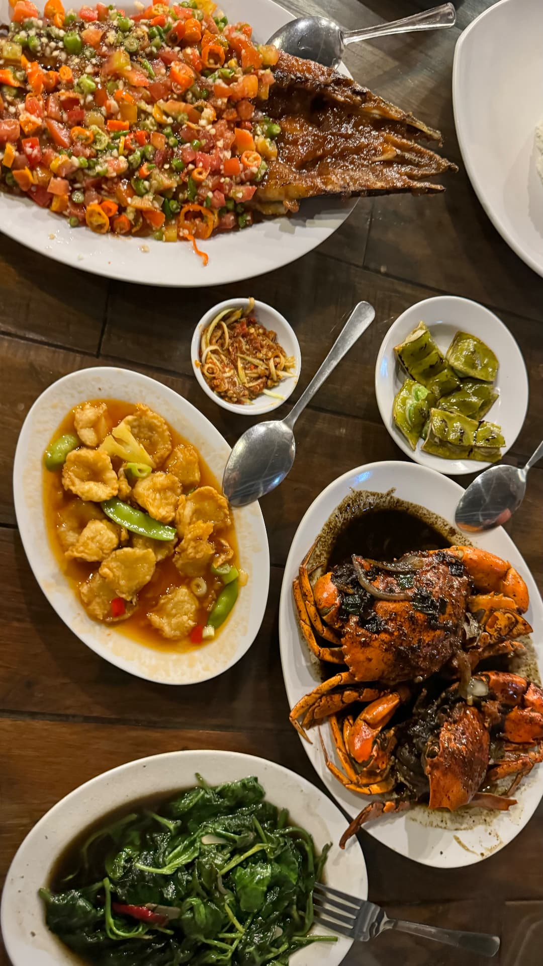 Indonesian seafood and vegetable dishes shared at dinner