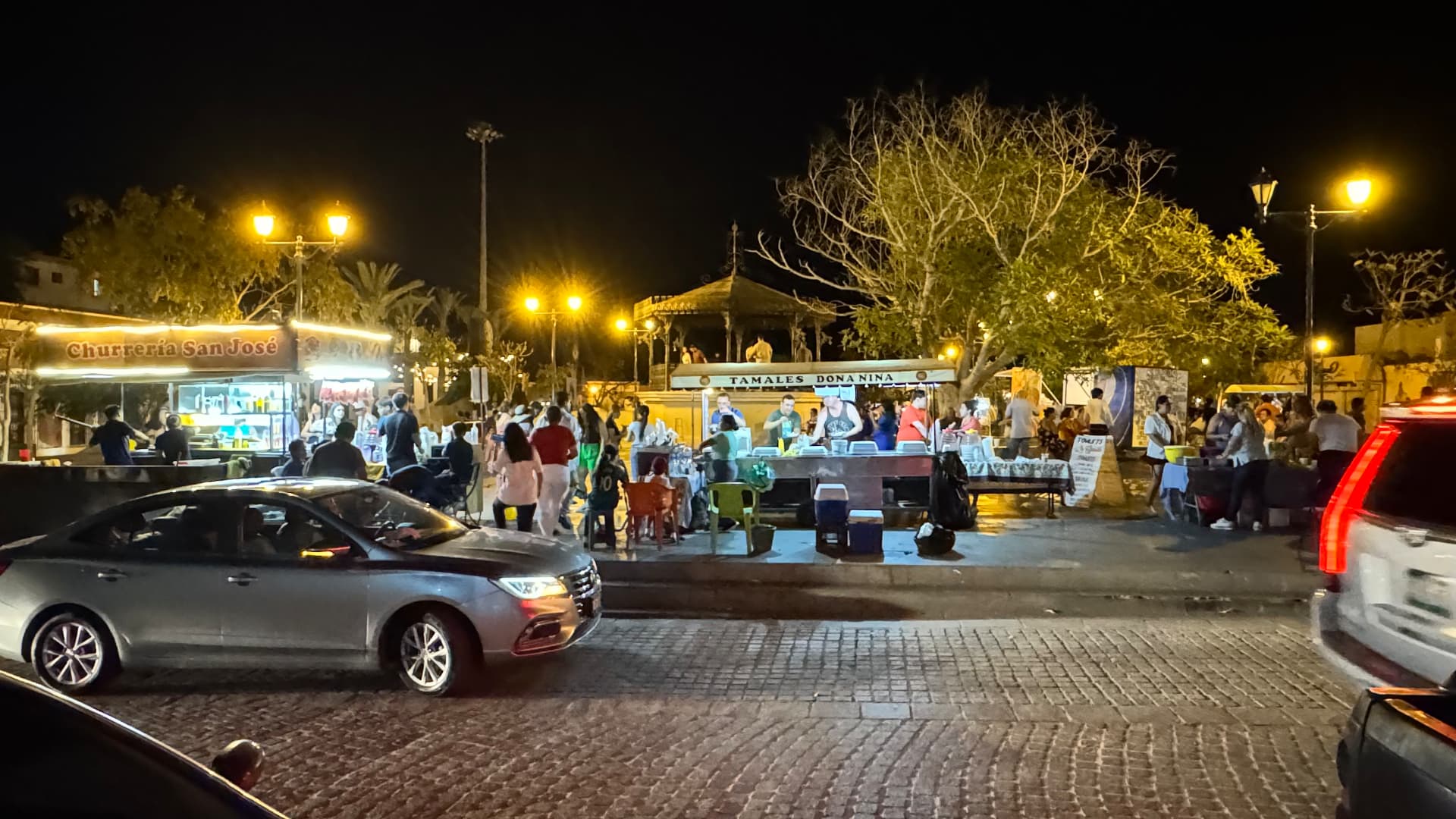 Busy night market with churros and tamales vendors in San José del Cabo