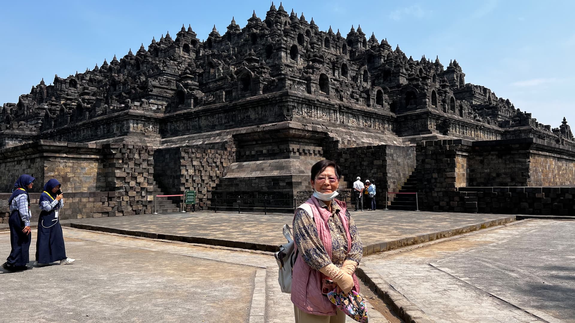 A family member in front of the temple's stone tiers