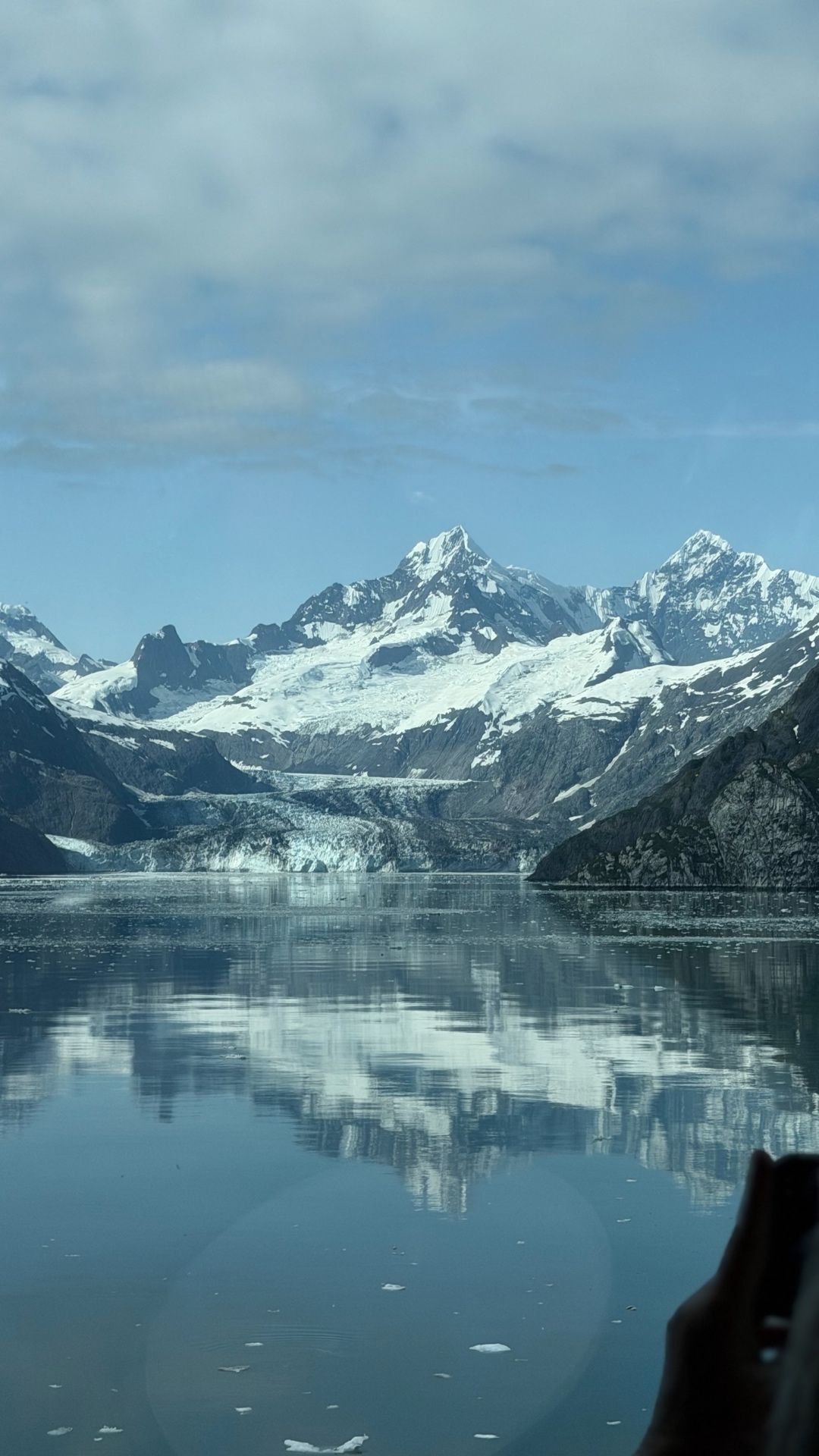 Portrait view of snowy peaks, a glacier and their reflection in Glacier Bay