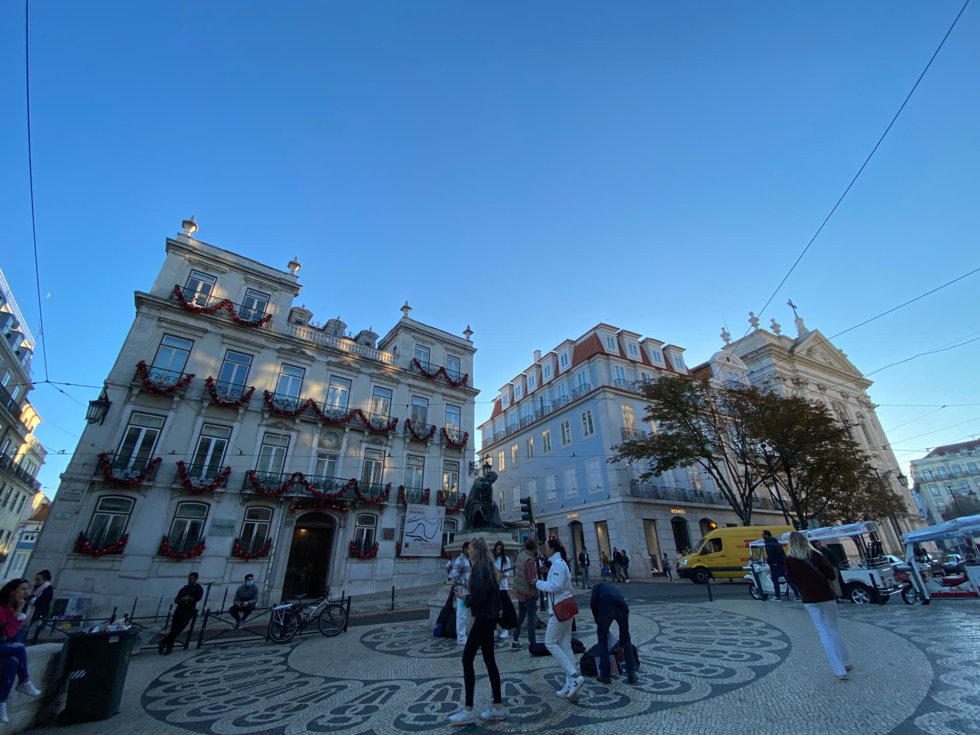 A wide Lisbon square ringed by historic buildings