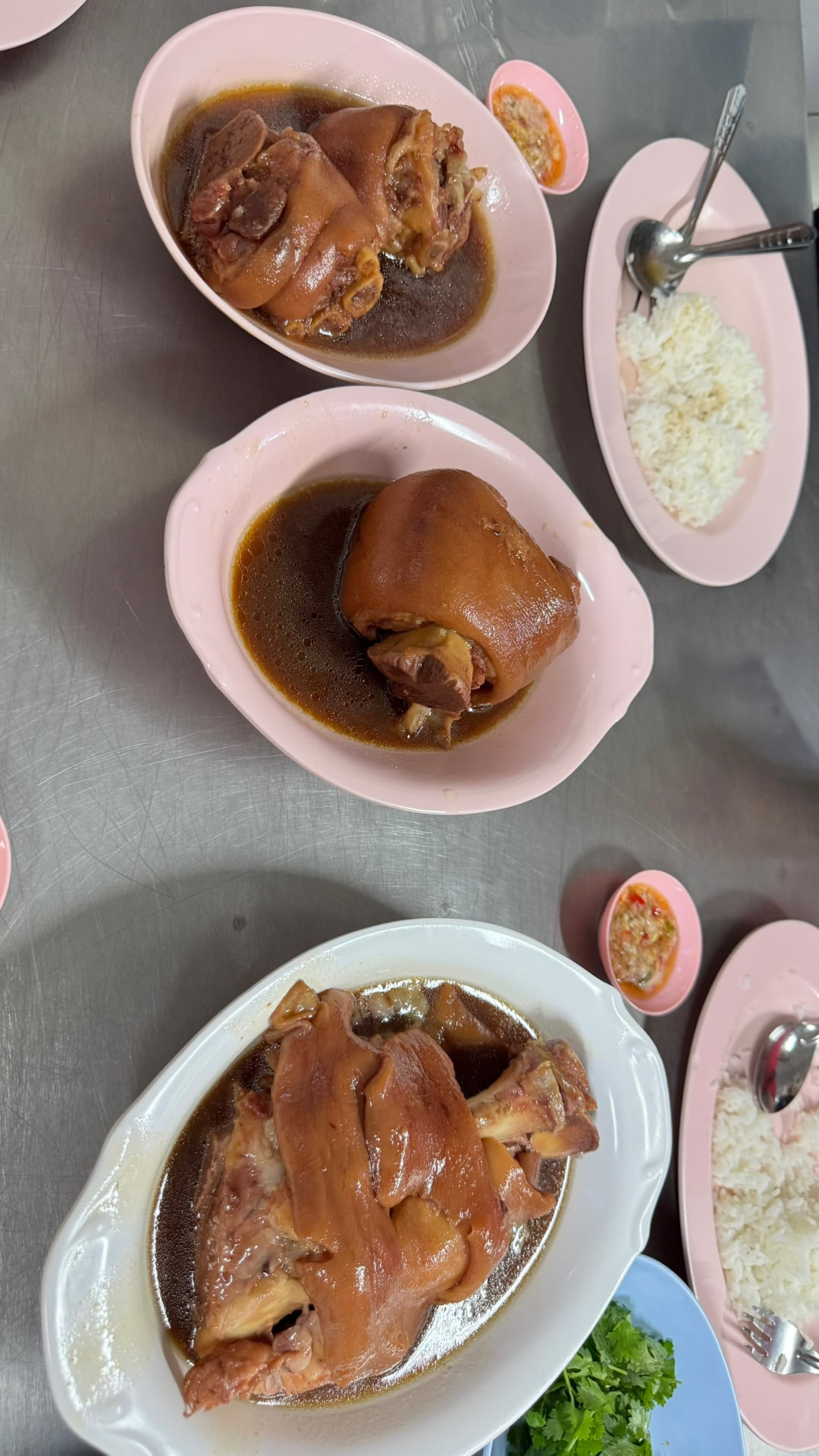 Platters of slow-braised pork leg with rice and chili sauce