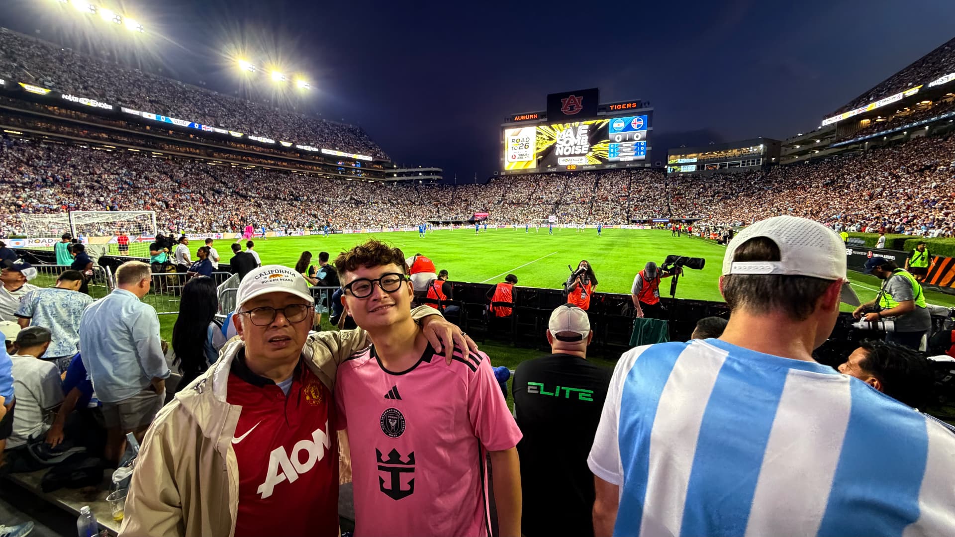 Ken and Johan together beside the field in a packed stadium