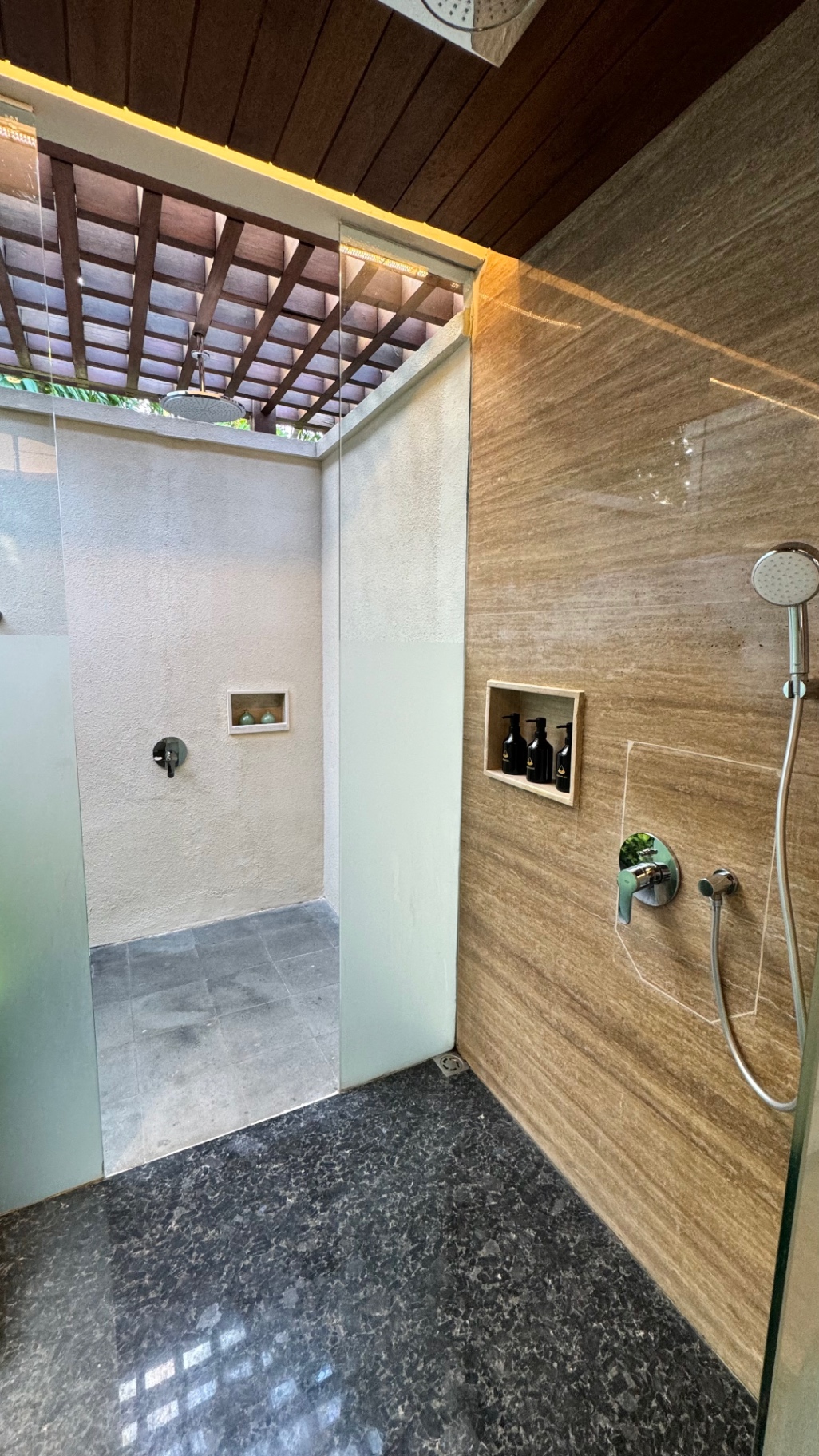 Villa shower with an open-air rain head under a timber lattice roof