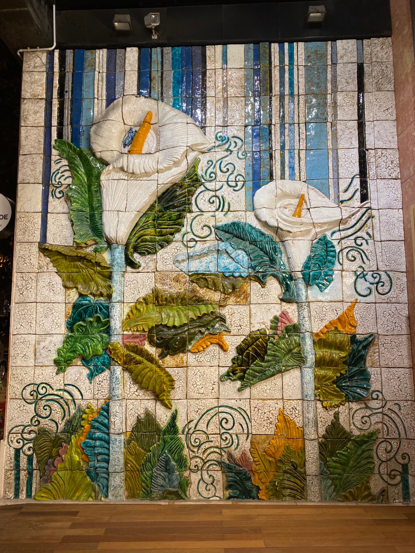 A tile mural of white calla lilies on a Lisbon wall