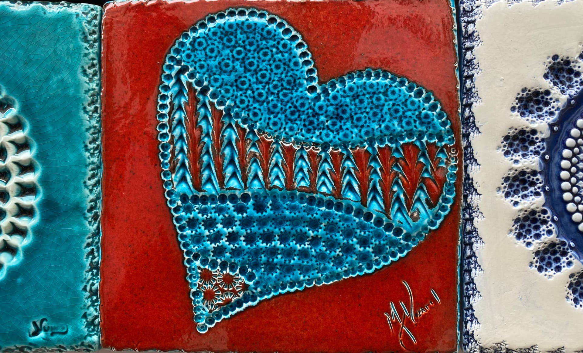 Colourful azulejo tiles with a blue heart on a red ground