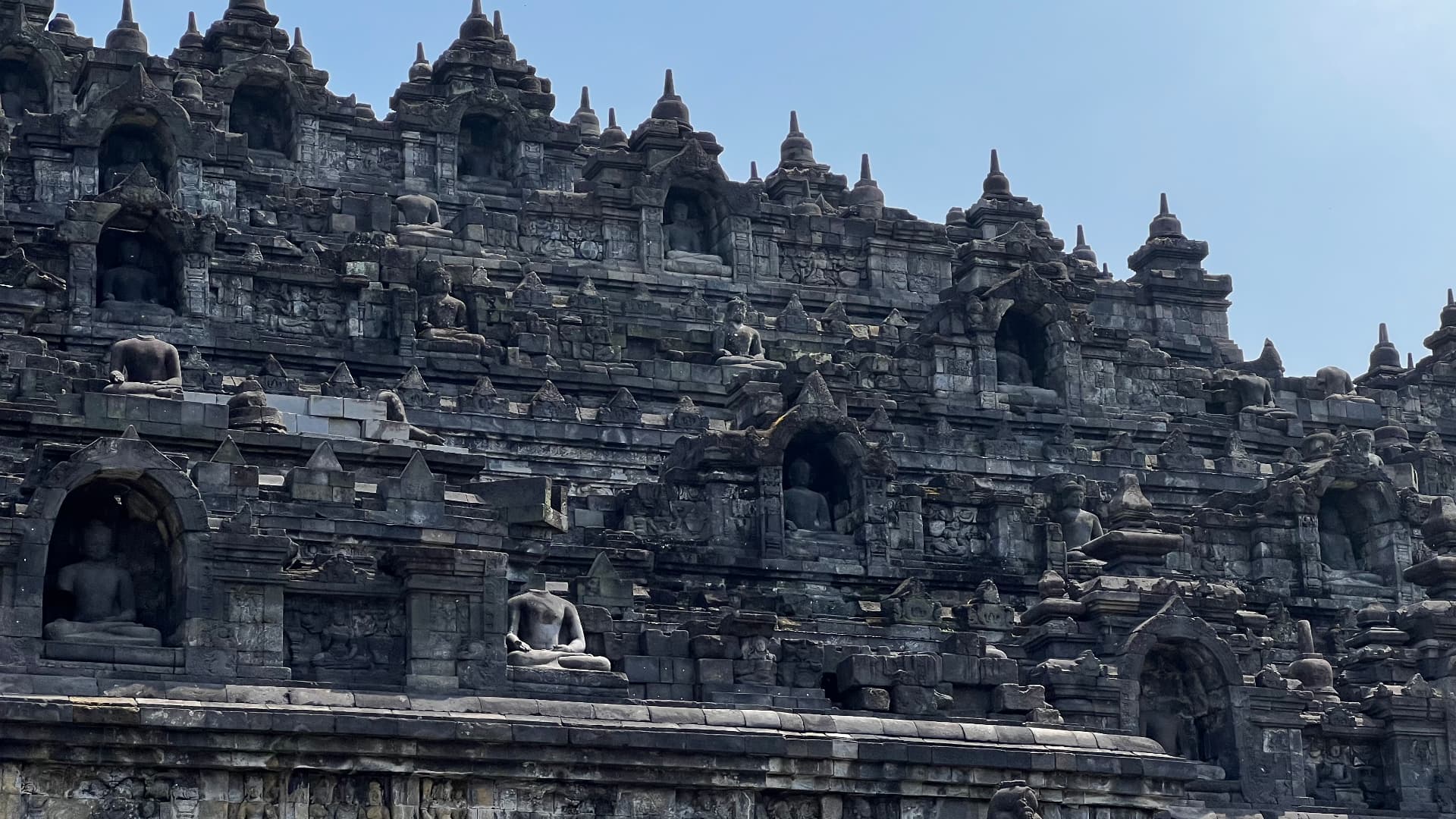 Close view of Buddha figures set into the stone niches