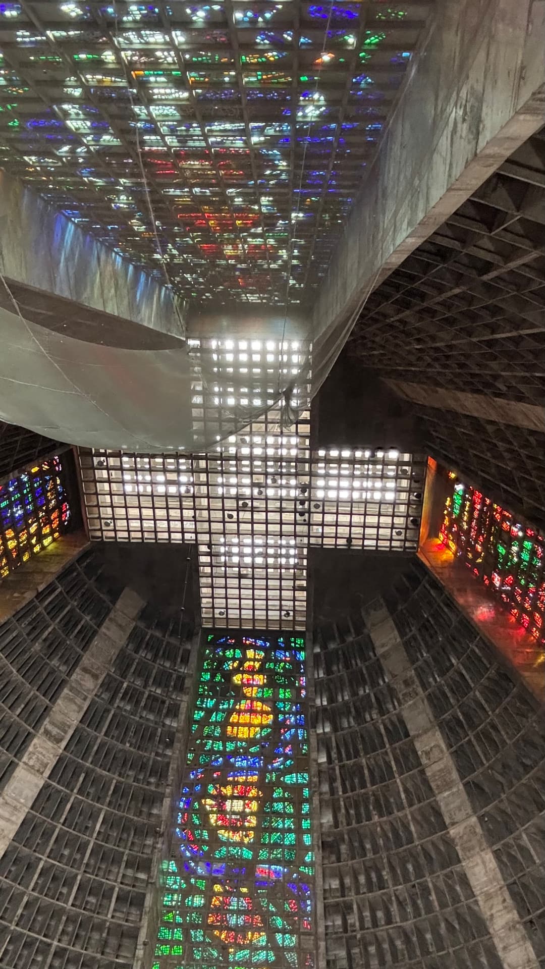 Stained-glass panels casting colour across the cathedral ceiling