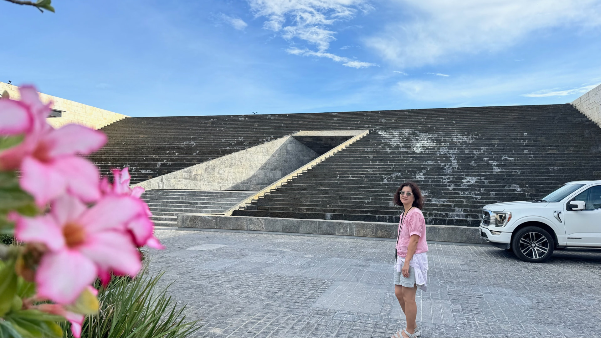 Becky standing before a monumental stepped stone entrance