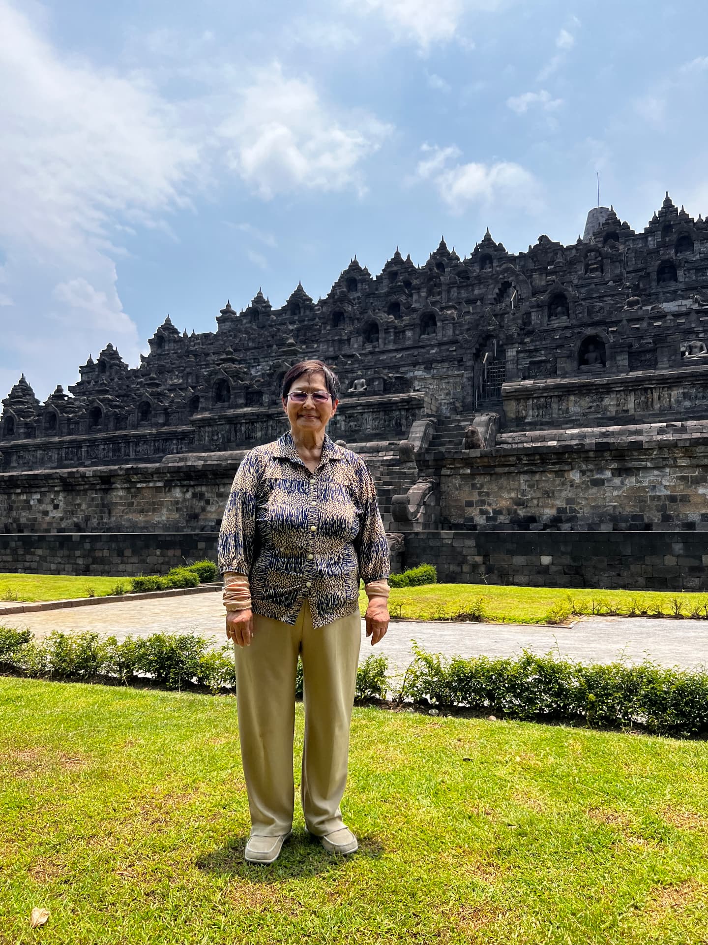 A family member standing on the grass outside Borobudur