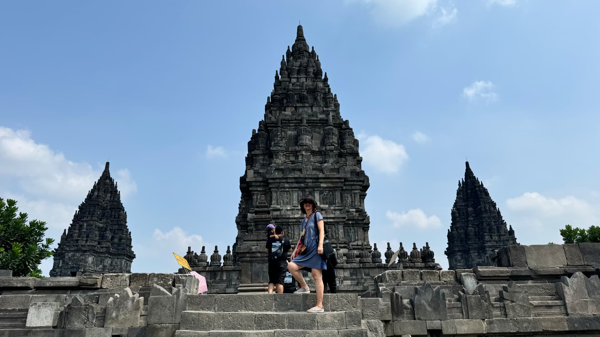 Traveler standing on the steps in front of a Prambanan temple