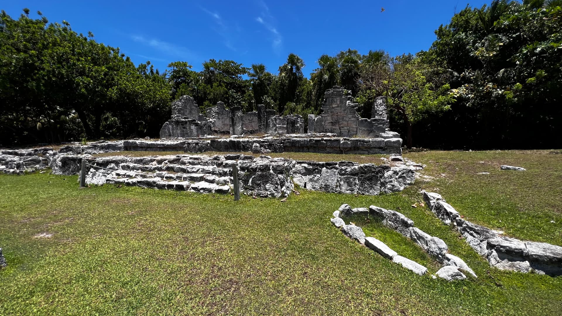 Limestone temple ruins beneath a vivid blue sky