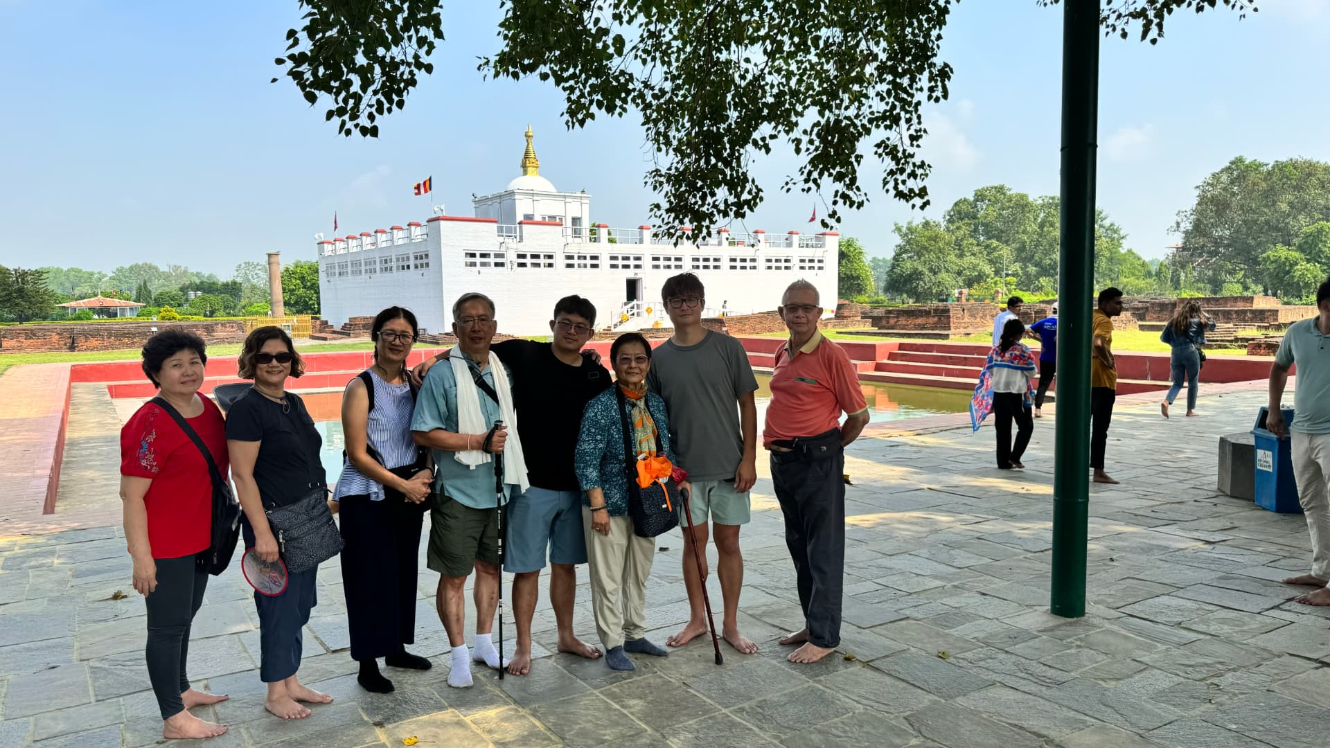 A group portrait beneath the trees of the sacred garden. — Lumbini, Nepal.