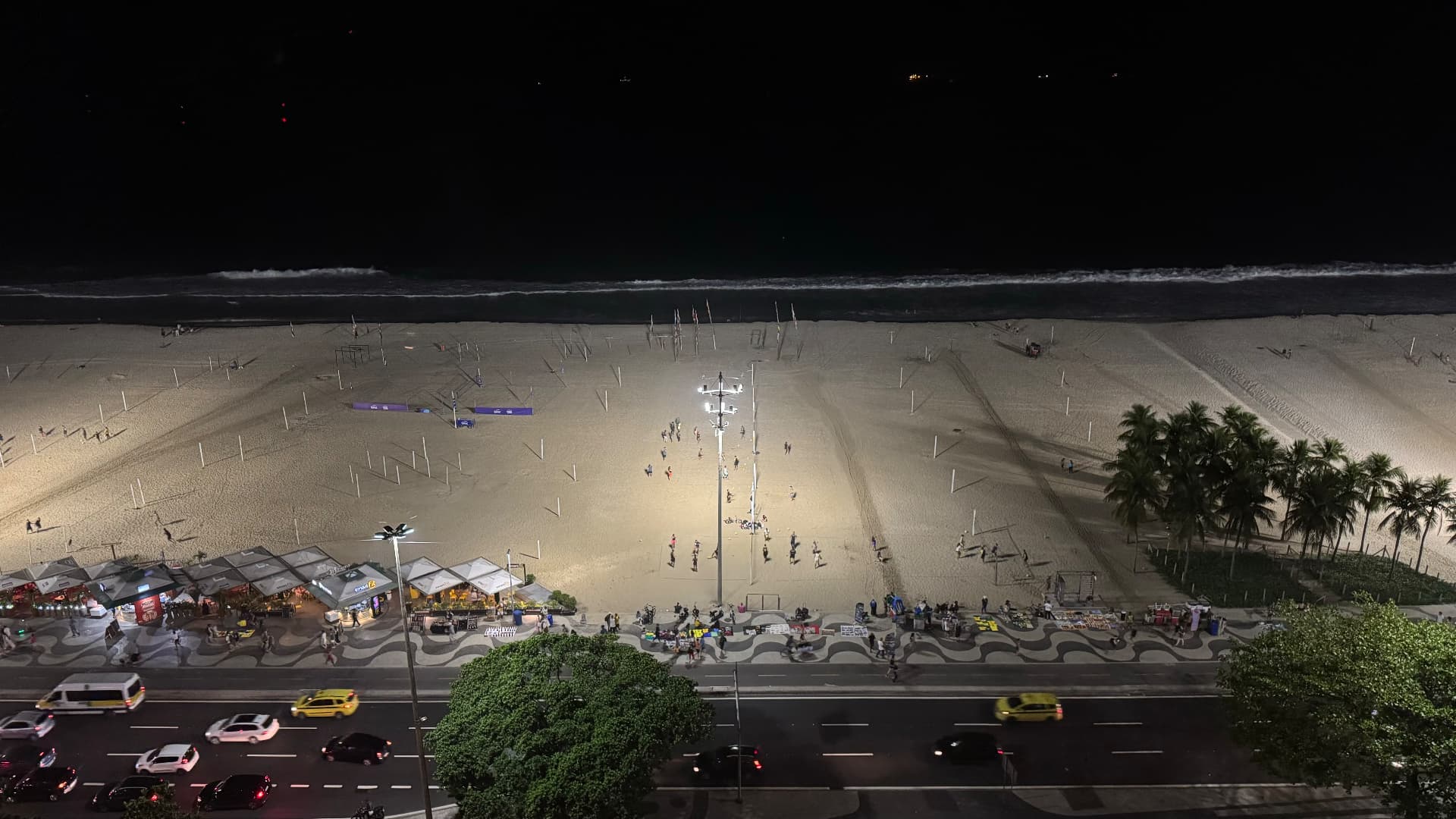 Copacabana Beach, promenade, kiosks, and traffic illuminated at night