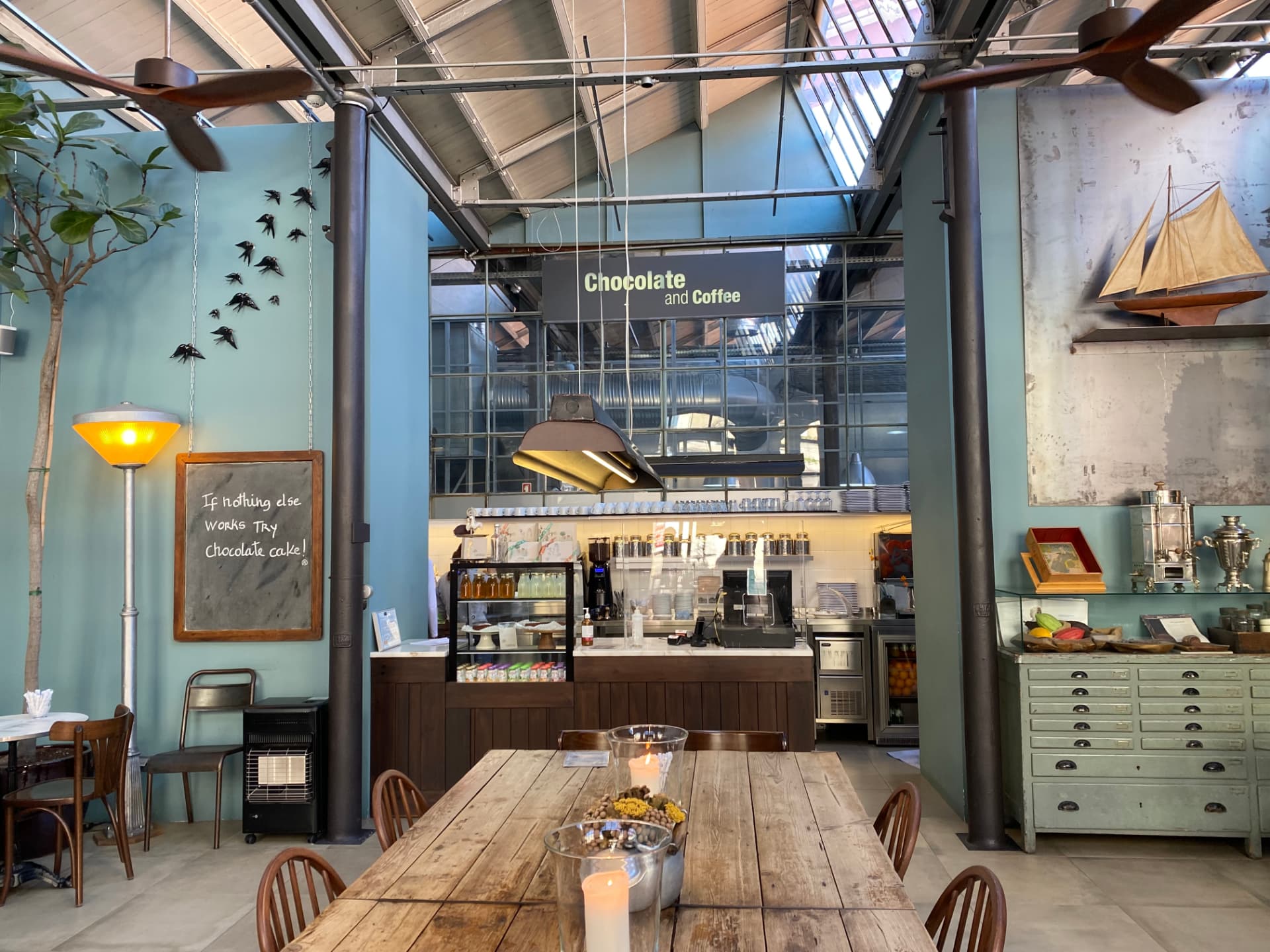 The interior of a modern Lisbon café with high ceilings