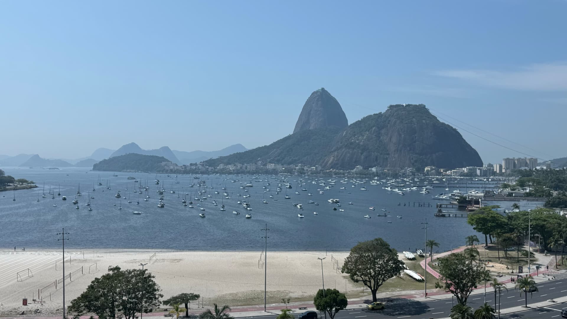 Sailboats filling Botafogo Bay beneath Sugarloaf Mountain