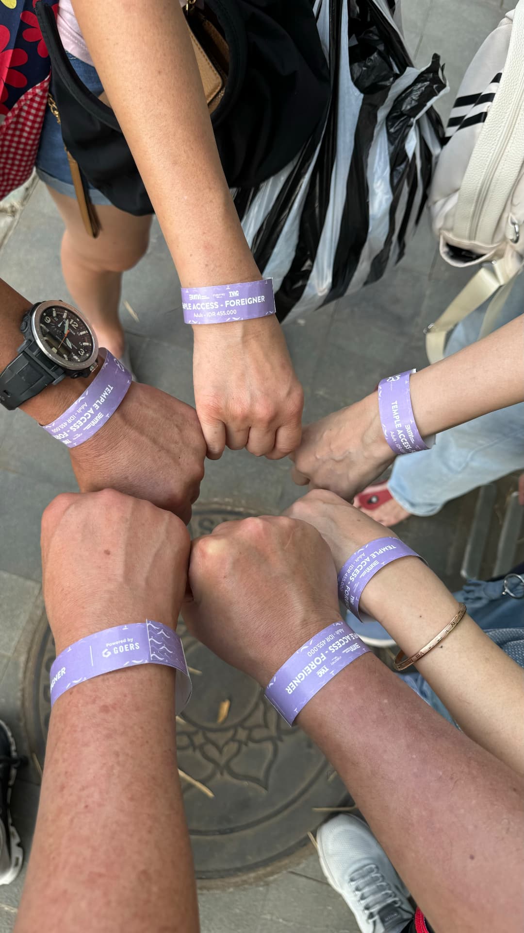 Travel companions showing their temple-access wristbands