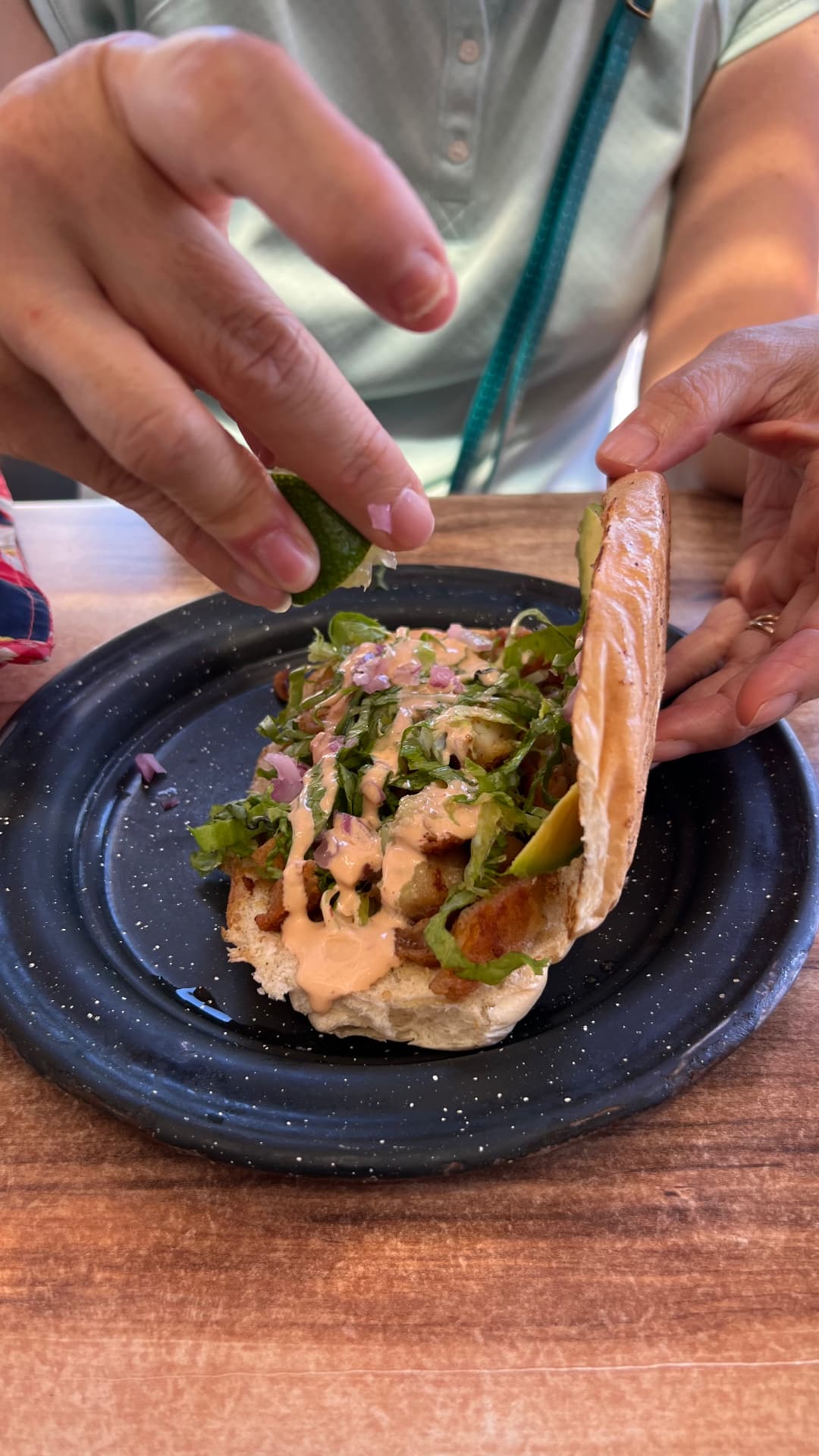 Fresh fish taco being finished with lime
