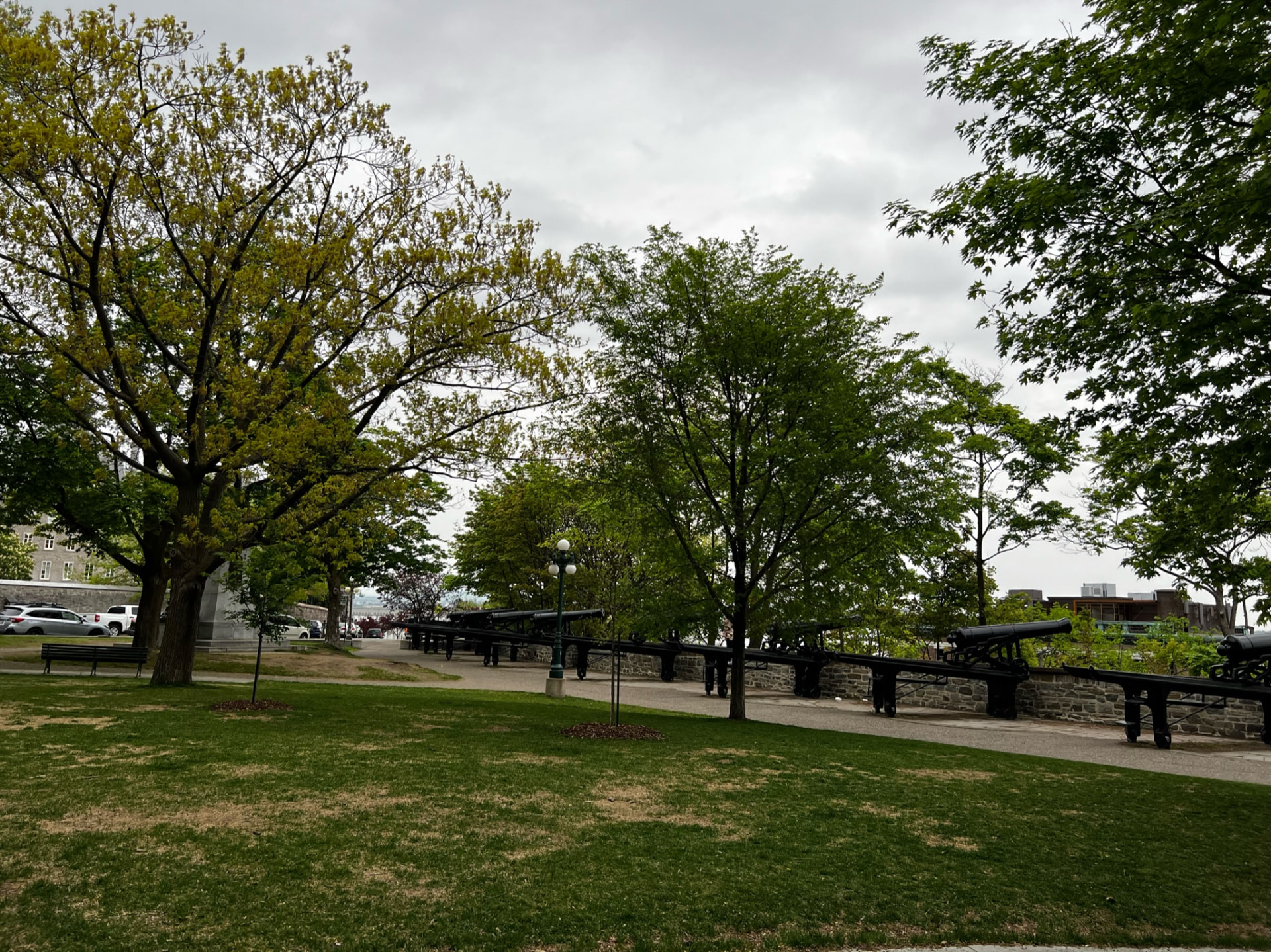 Tree-lined park with historic cannons along the wall in Québec City
