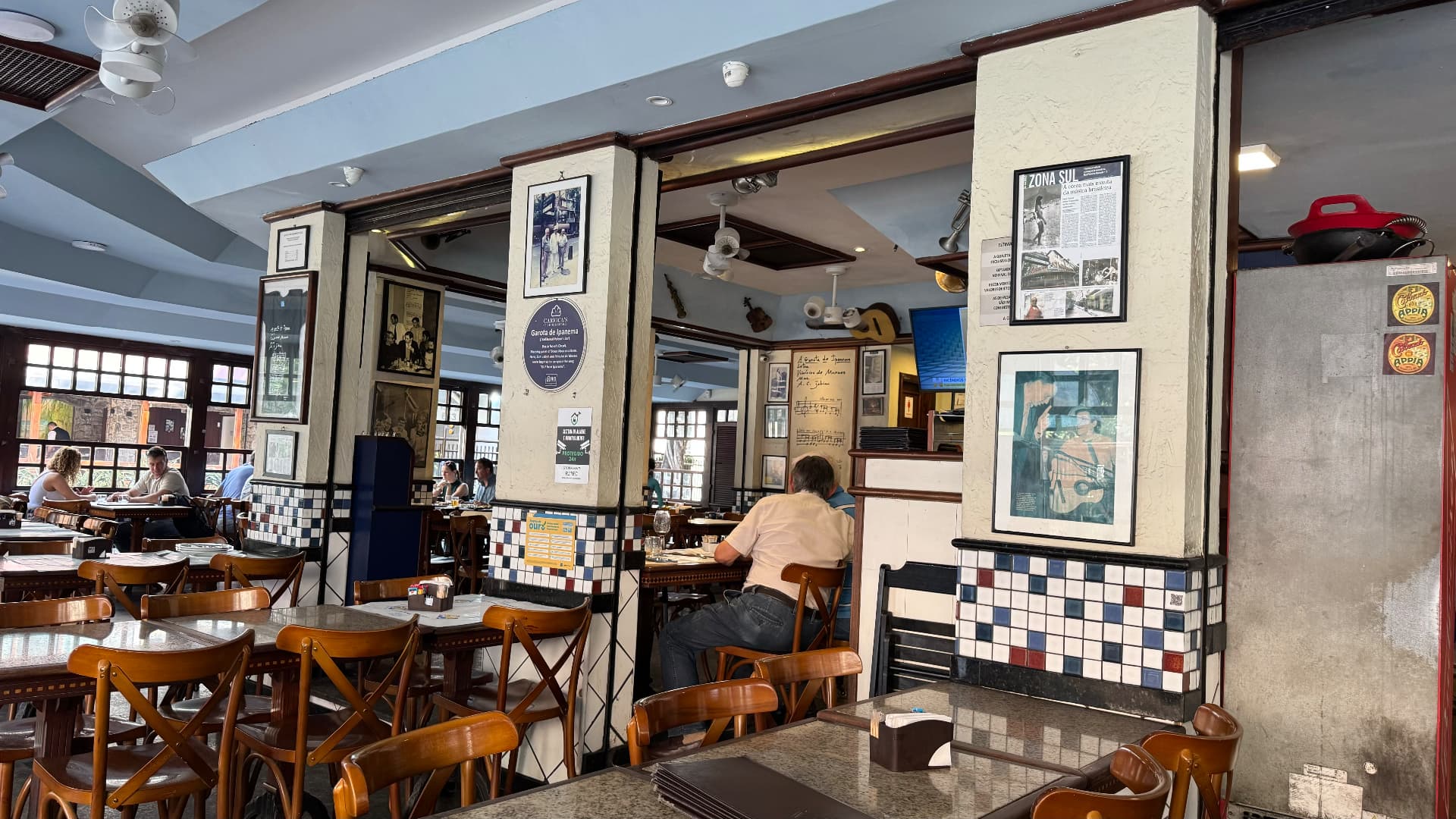 Dining room of A Garota de Ipanema lined with photographs and musical memorabilia