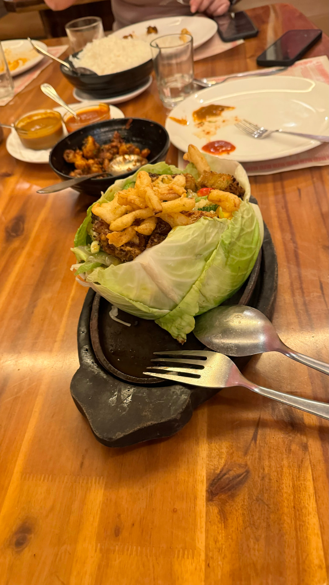 Fresh vegetables and a hot dish served on a wooden platter. — Varanasi, Uttar Pradesh, India.