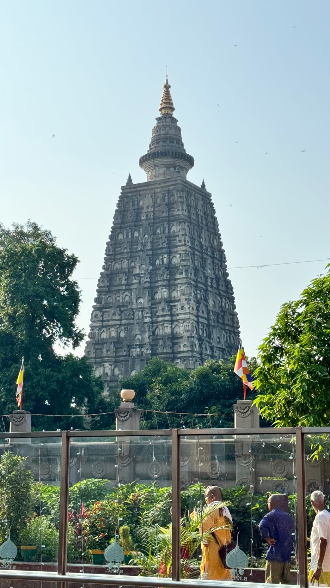 The carved Mahabodhi Temple spire rises above the visitors below. — Bodh Gaya, Bihar, India.