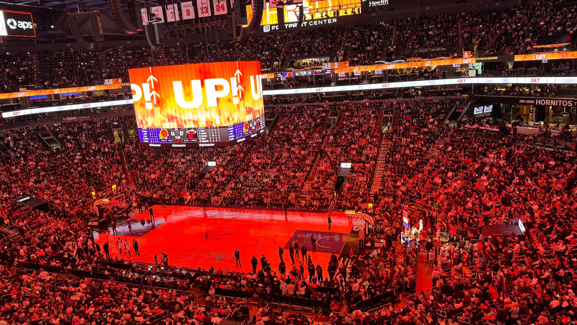 Inside Footprint Center with the jumbotron lit up in orange and the crowd on its feet