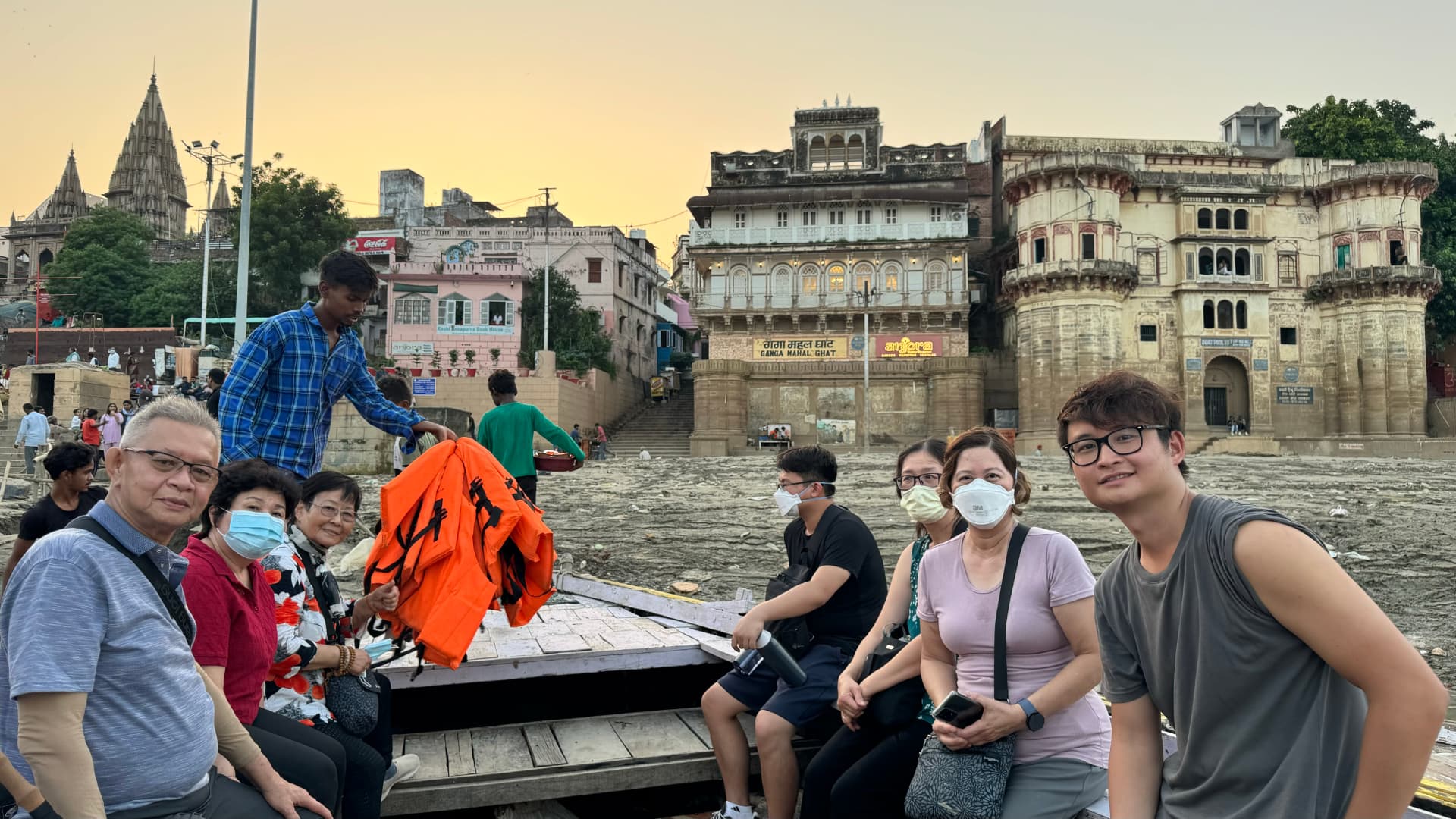 A group photograph aboard the boat, with the ghats behind us. — Varanasi, Uttar Pradesh, India.