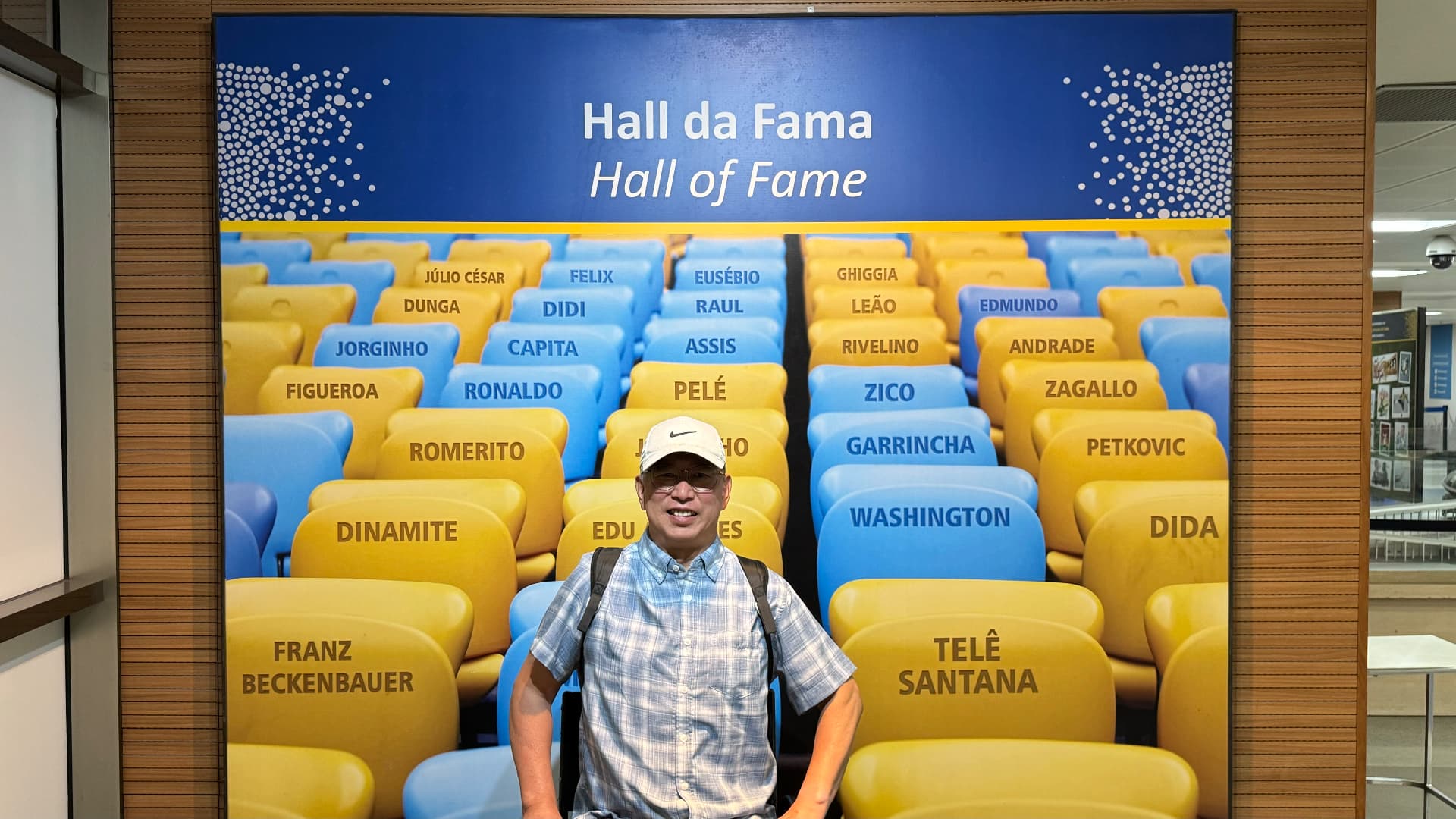 Ken in front of Maracanã's Hall of Fame display naming celebrated footballers
