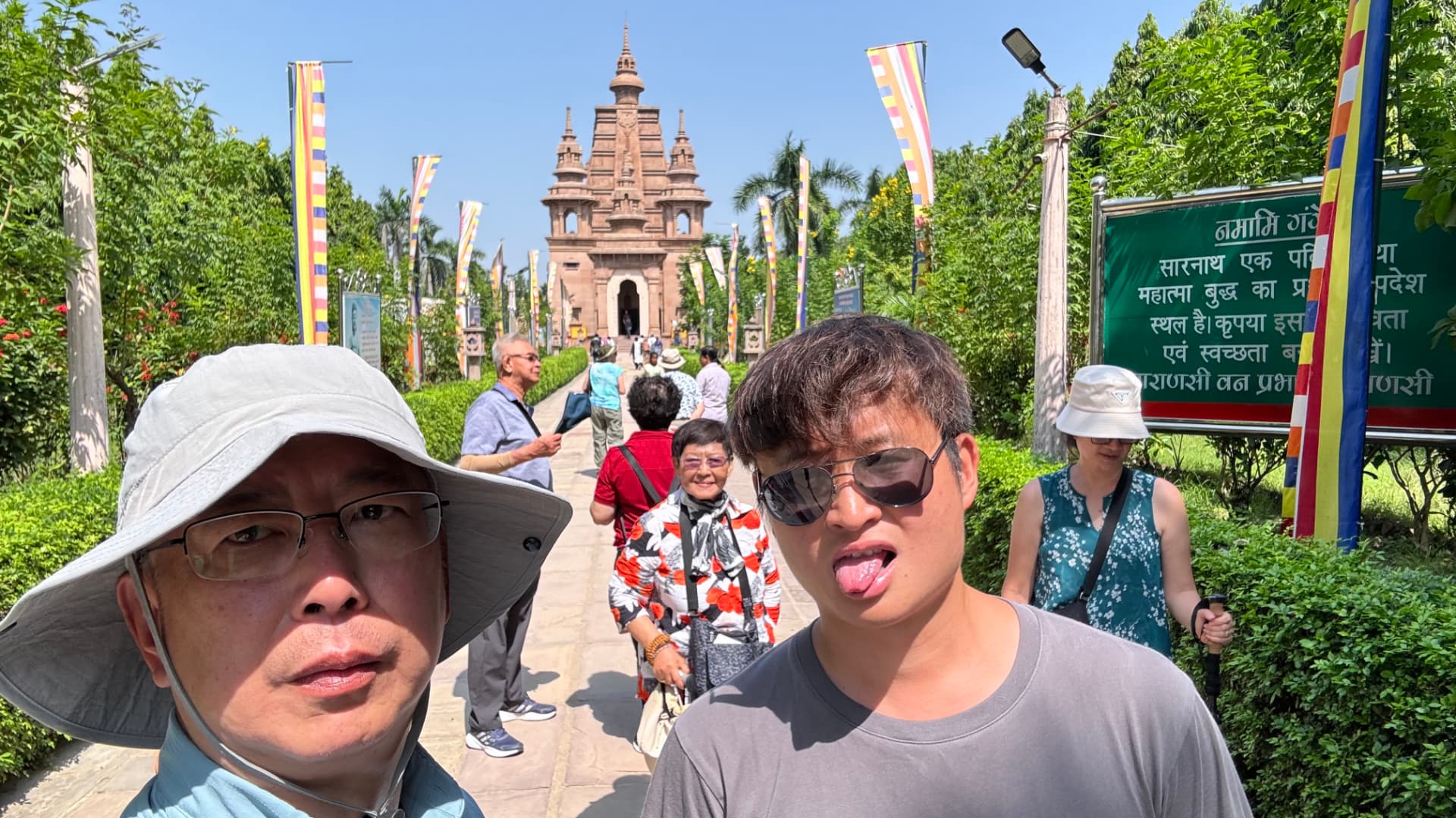 A cheerful close-up with the temple and gardens in the background. — Sarnath, Uttar Pradesh, India.