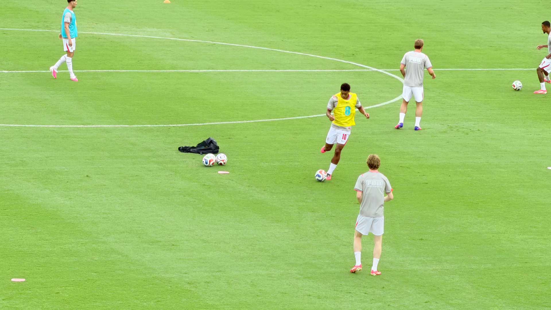 England players passing the ball during their warm-up