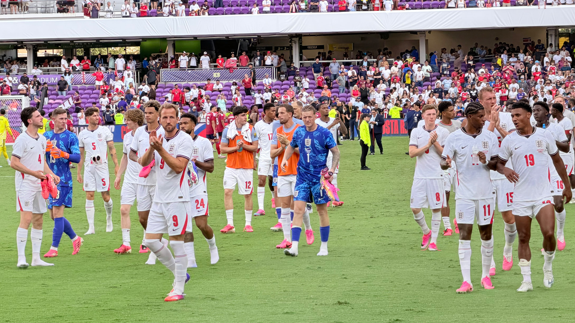 England players applauding the travelling supporters after a warm-up match