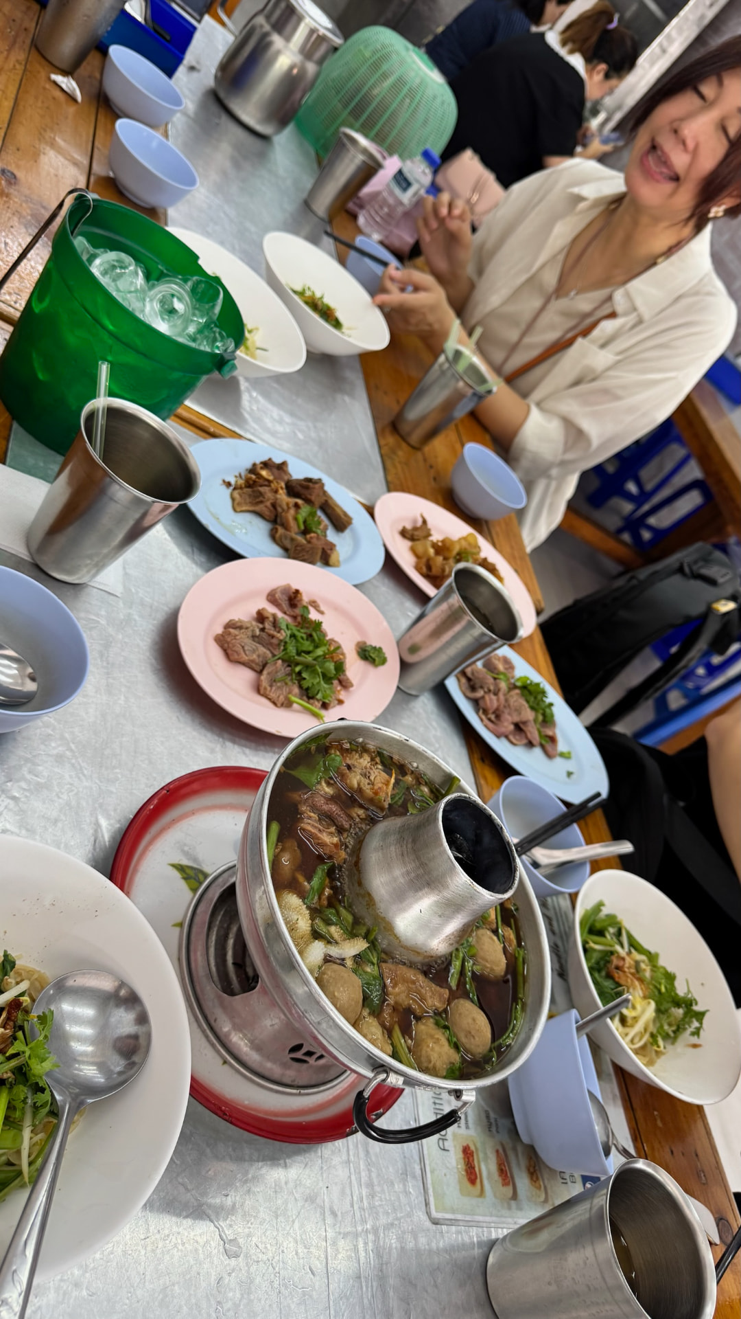 Beef hot pot and shared plates on a Bangkok restaurant table