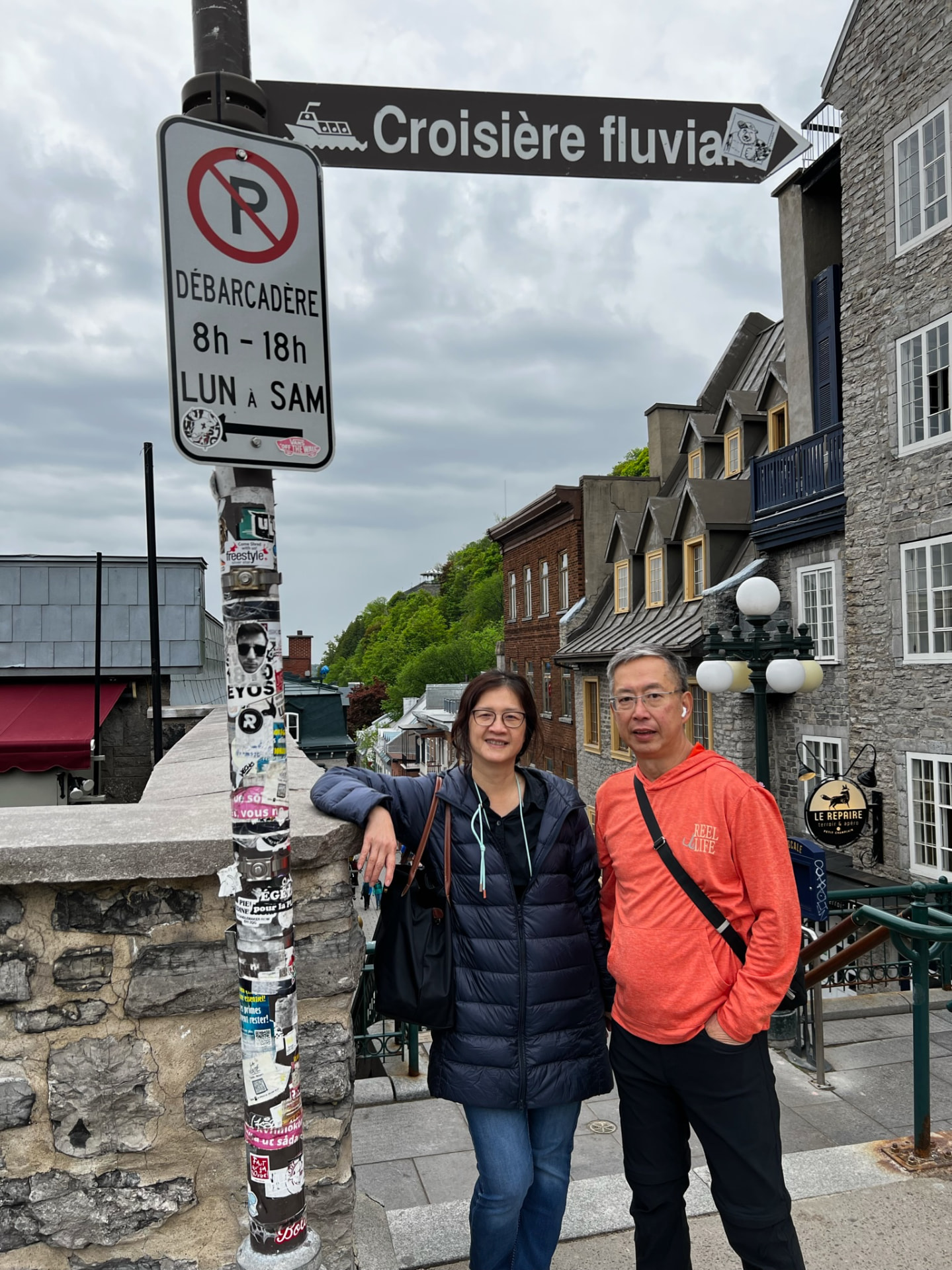 Ken and a family member beside the river-cruise sign above Petit Champlain