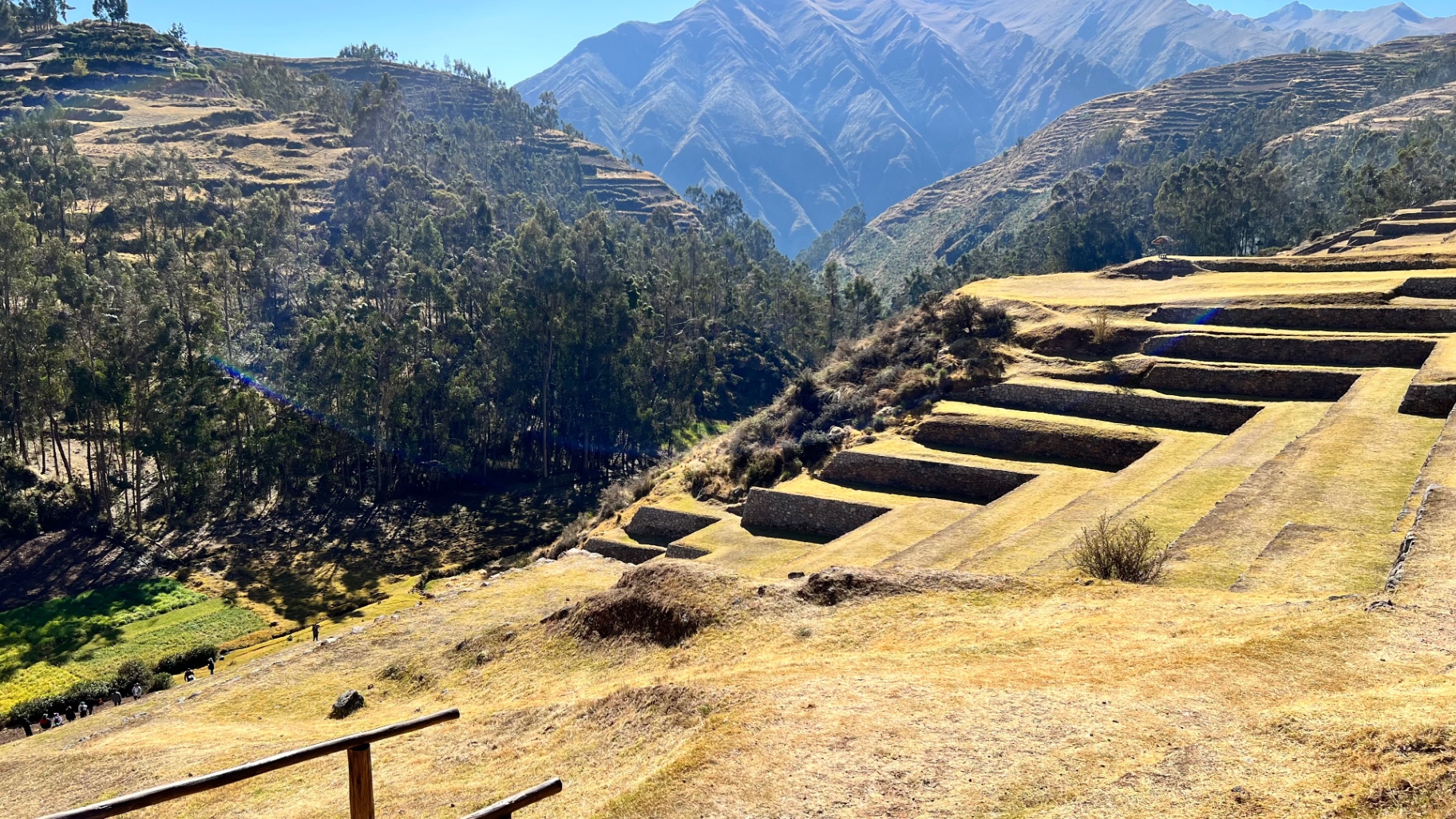 Sunlit agricultural terraces descending toward the green valley