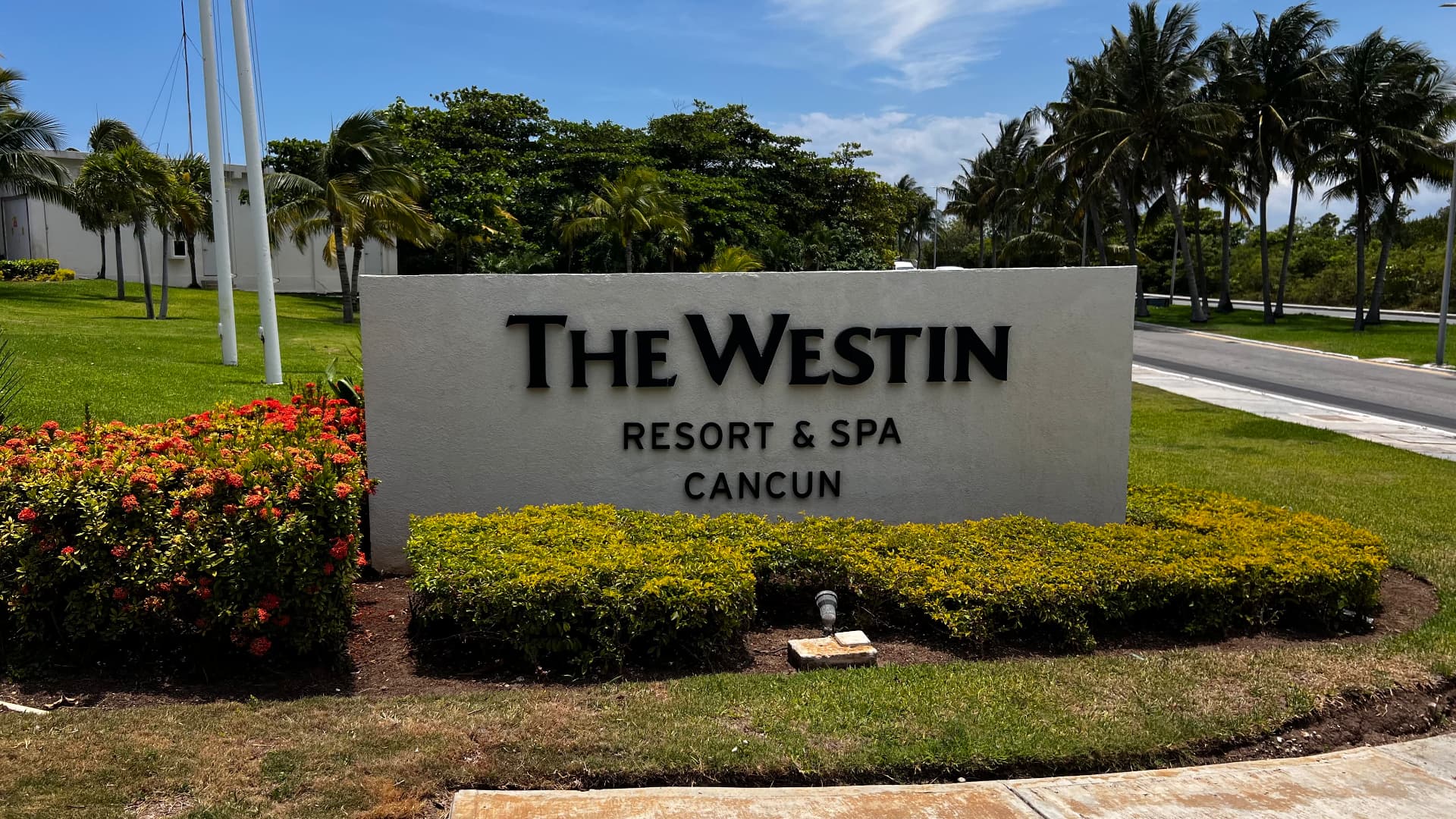 The Westin Resort and Spa Cancún entrance sign among palms